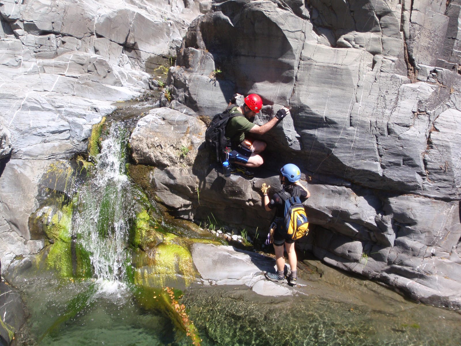 Monica gives Chris a hand getting down a small waterfall.
