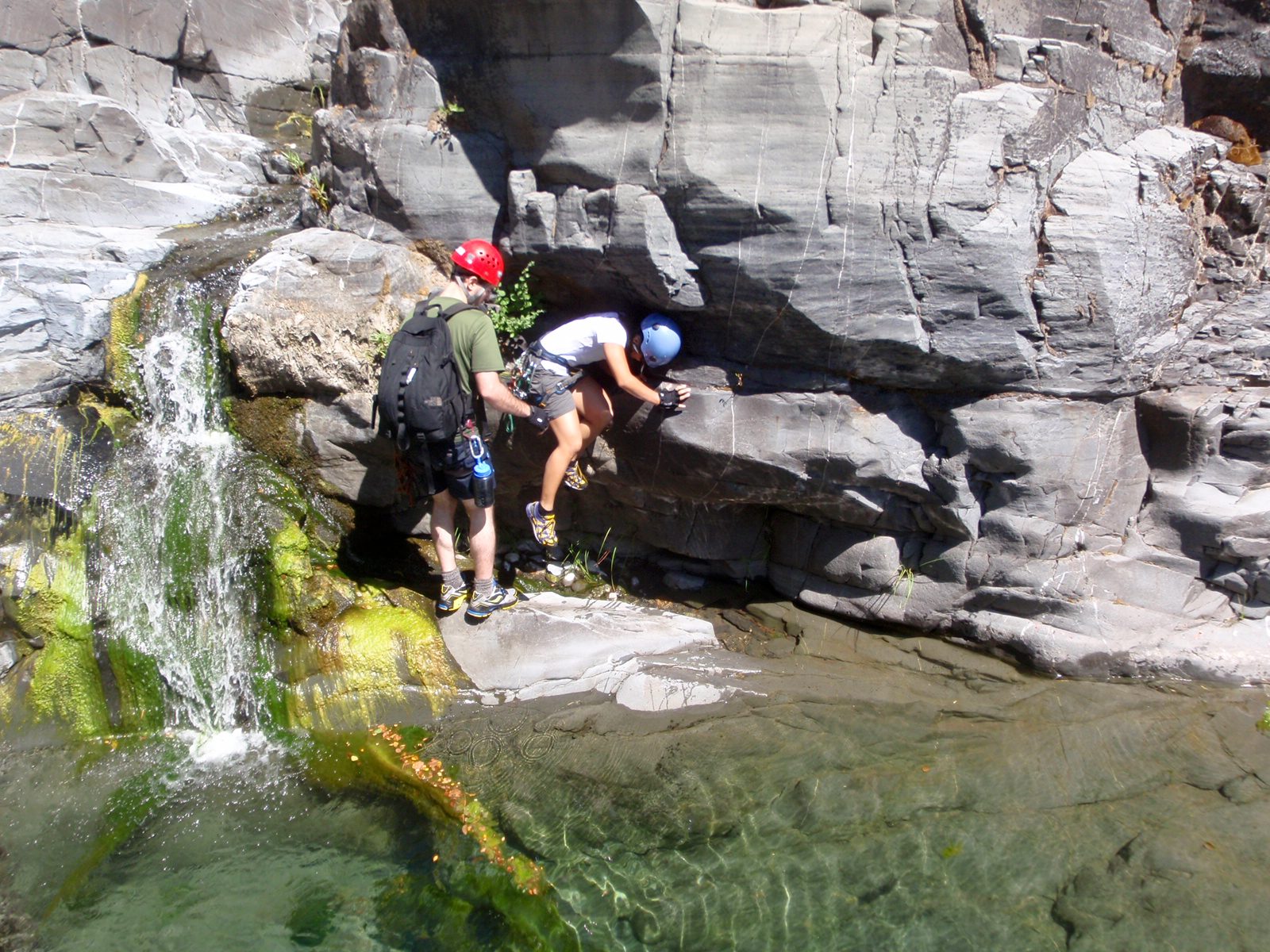 Chris helps Christina around the same waterfall.