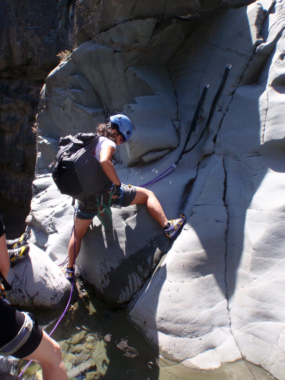 Christina, helping to set up the anchor on the second rappel.