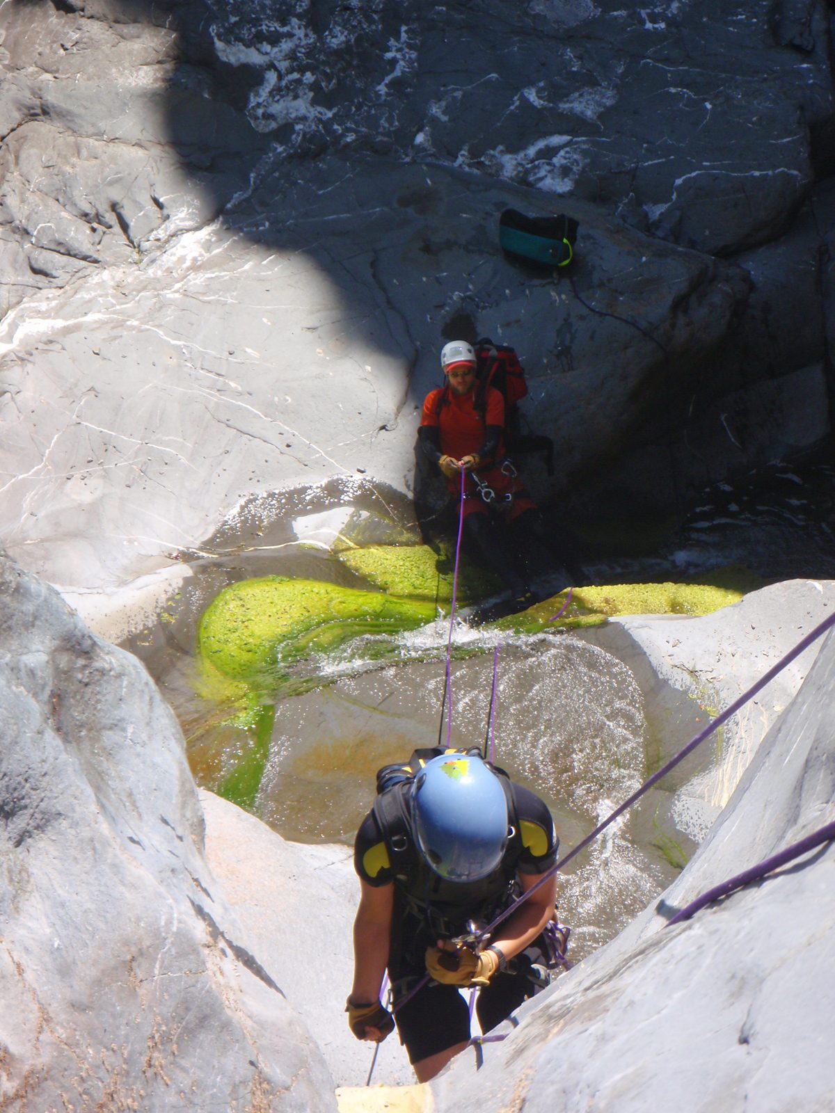Monica on rappel, while John gives a fireman's belay from the bottom.