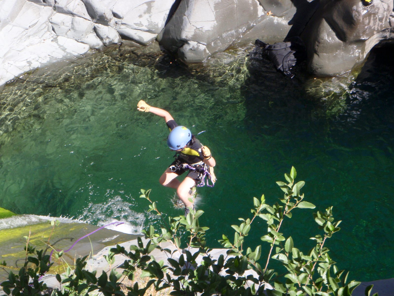 Monica jumps off the end of the rope into the 3rd rappel pool.