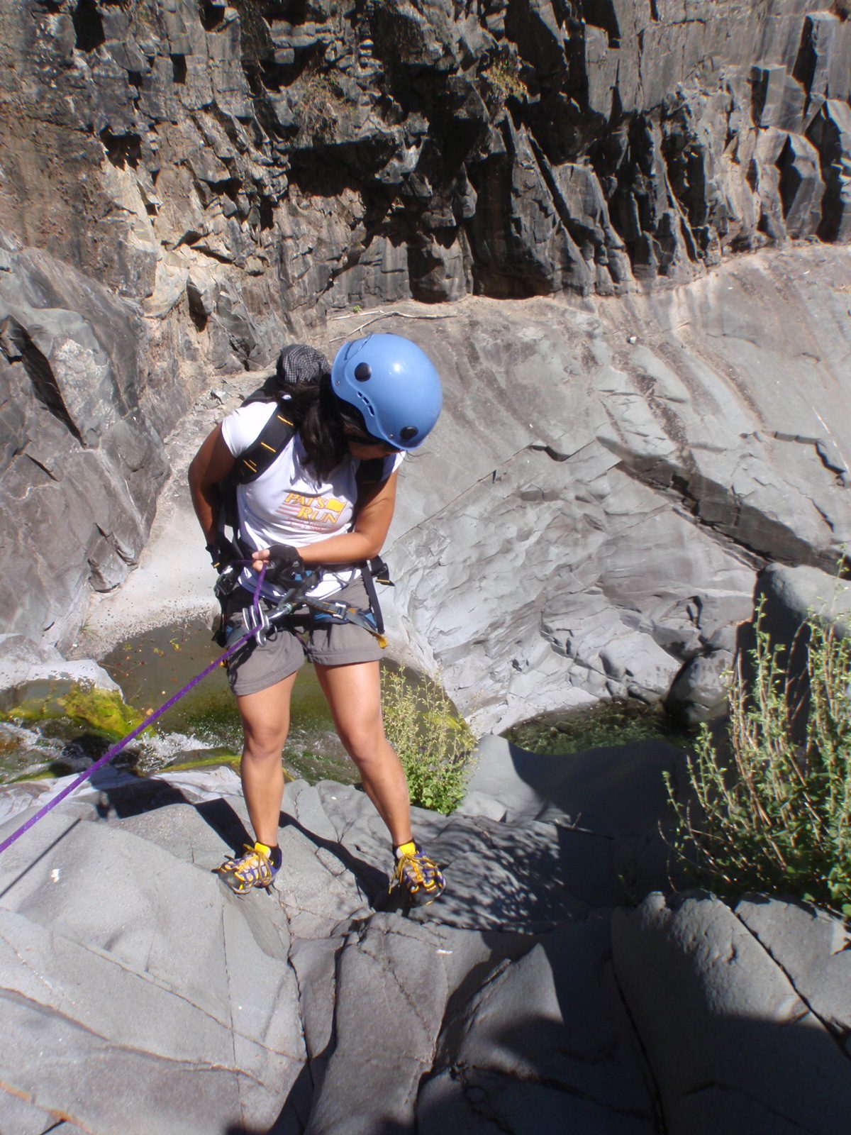 Christina lowers herself down the final rappel.