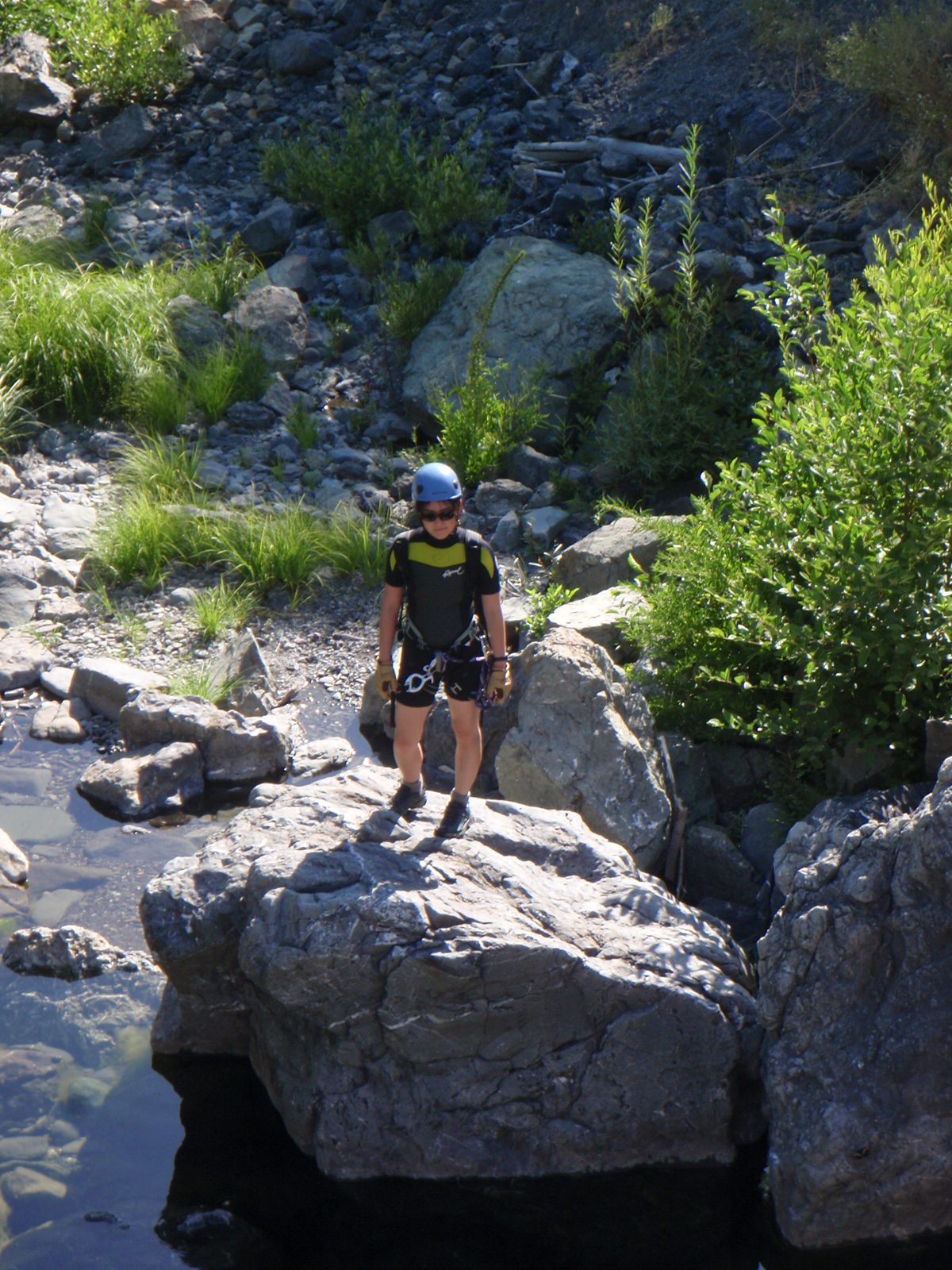 Monica, looking like some sort of superhero perched on a boulder.