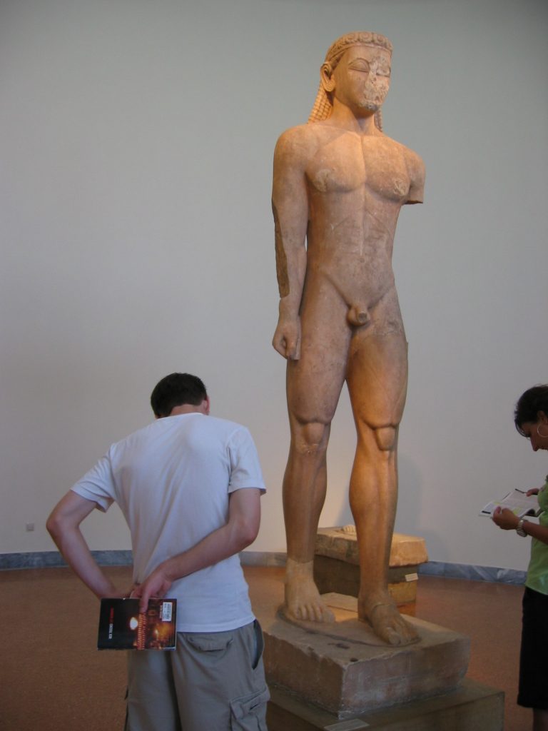 Nick studying a statue of a kouros, or boy.