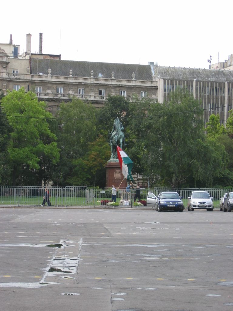 Hungarians raising the flag over a memorial to those slain during an uprising against the...