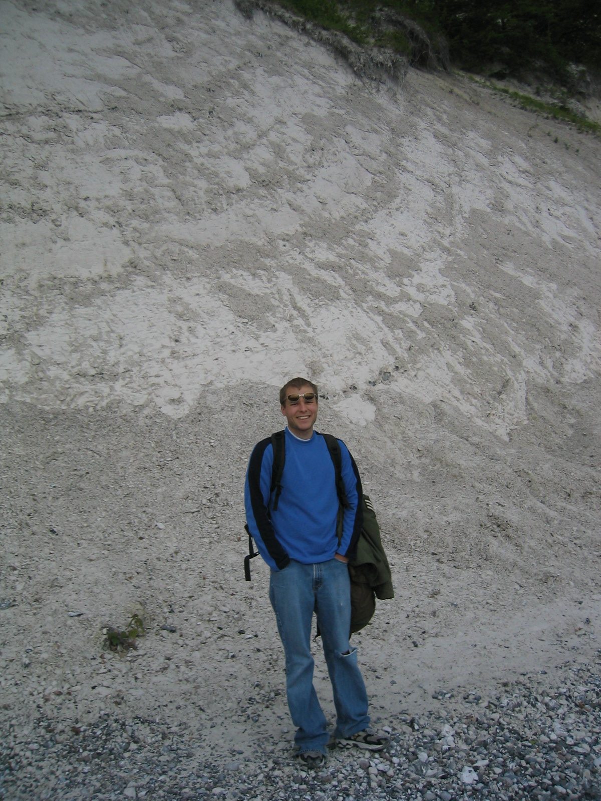 John on the stone beach at the foot of the cliffs, right before it started to rain.