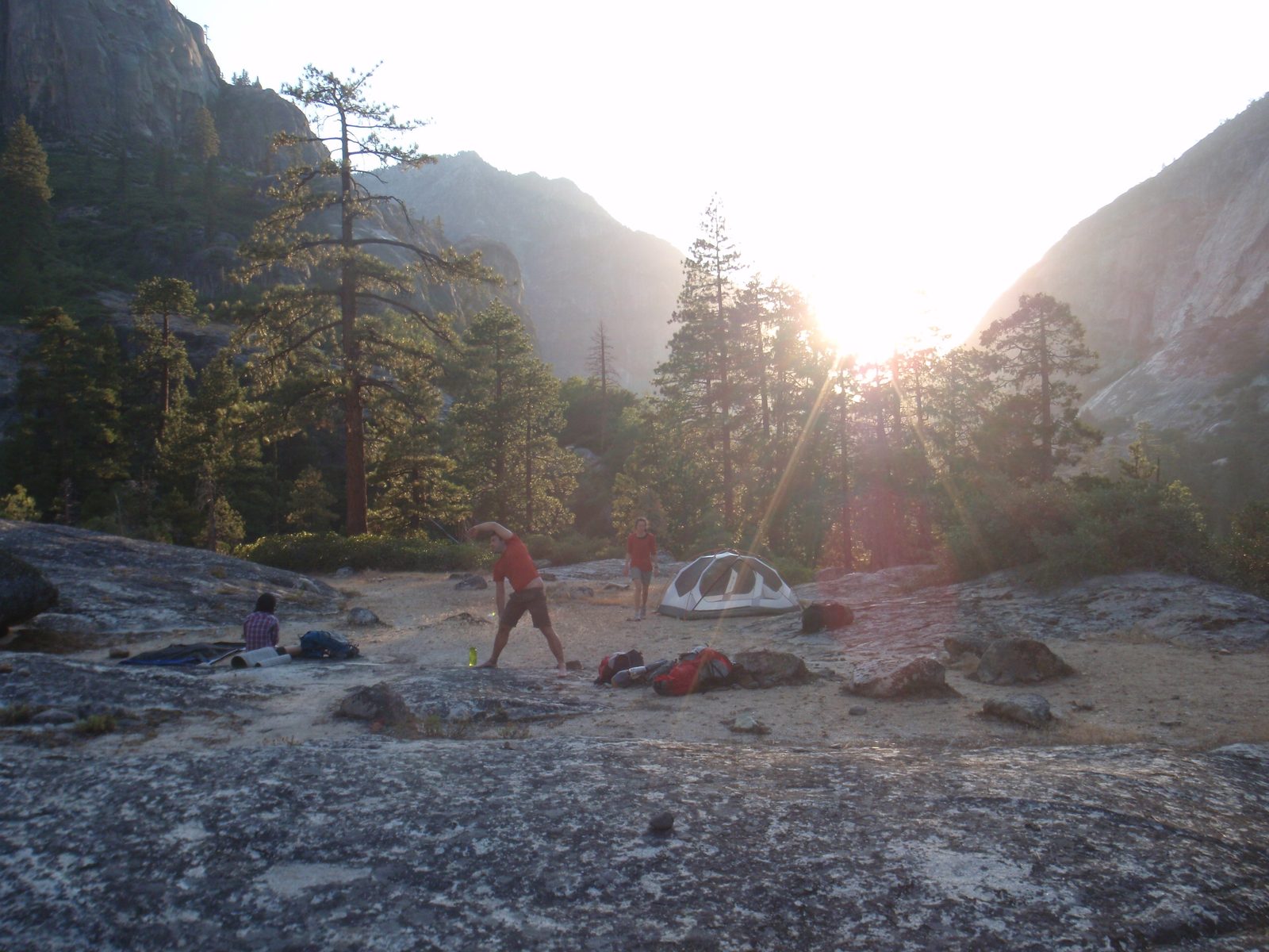Jasper doing some stretches in camp, and the setting sun to the west.