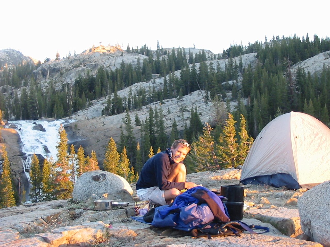 John looks dashing with a scarf tied around his neck.  Cooking dinner while fending off mosquitos.