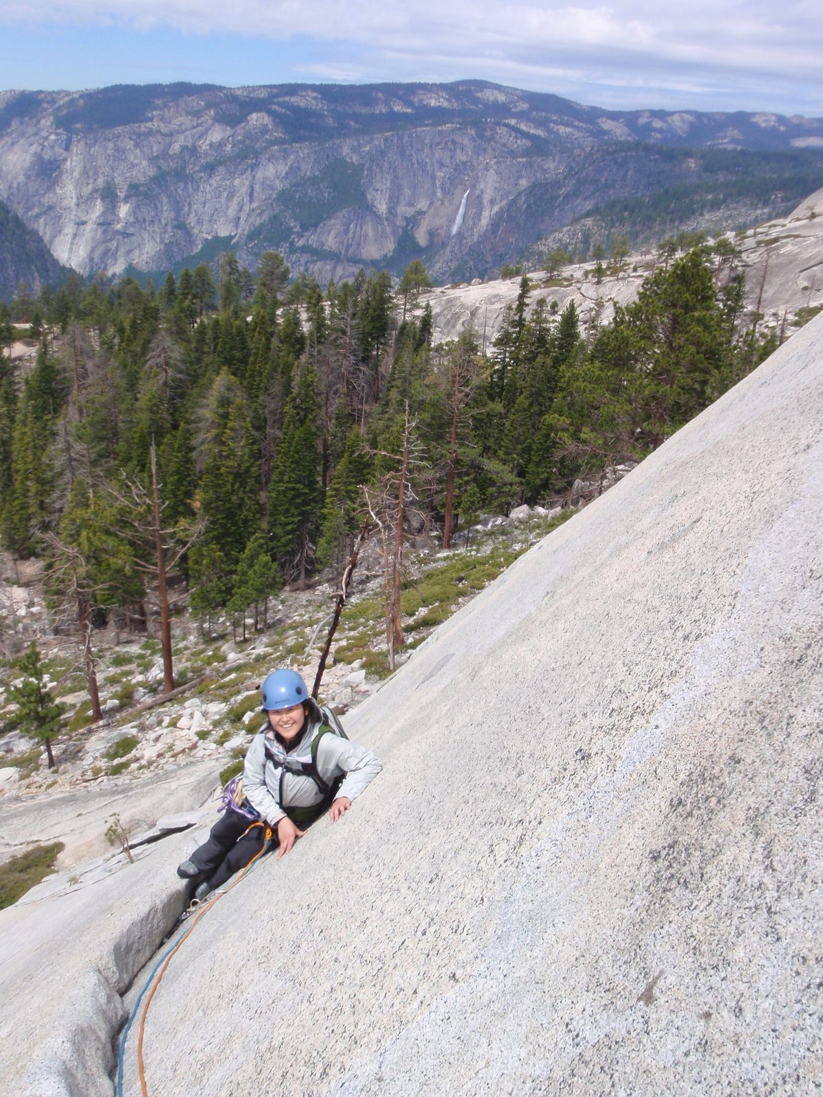Monica nearing the top of pitch 1 on Snake Dike, with Yosemite Falls in the background. We...
