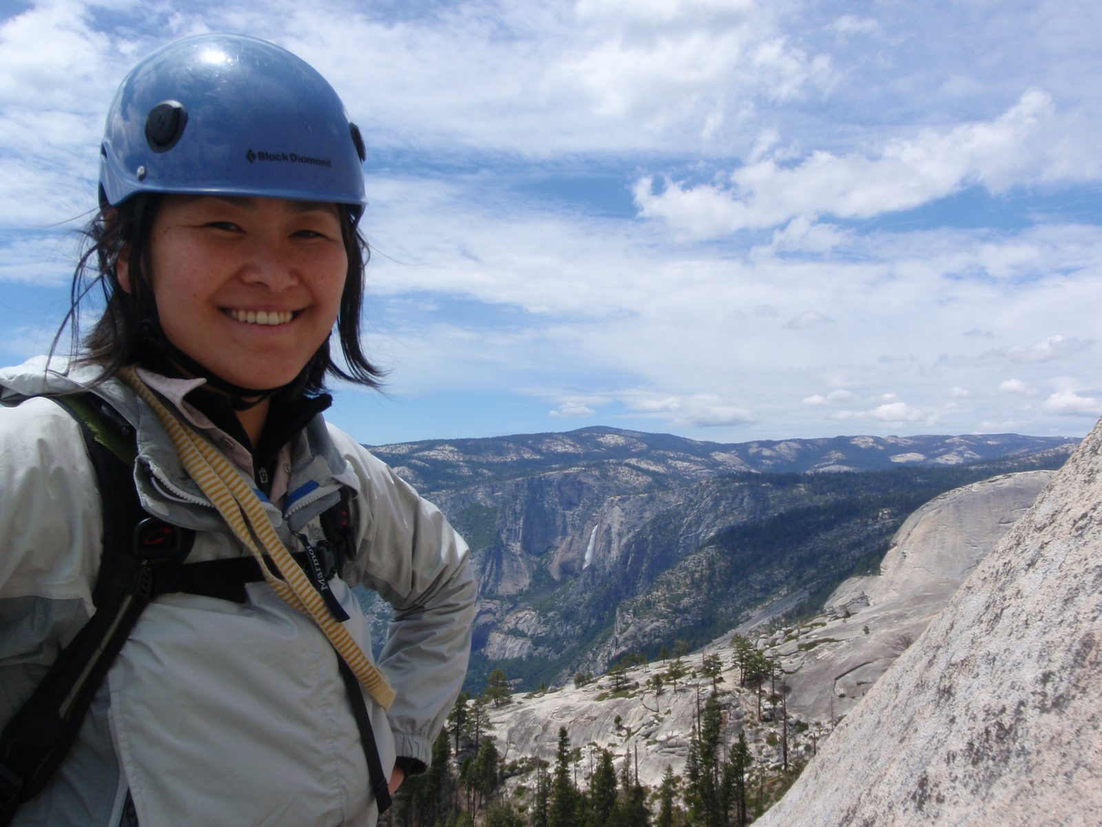 Monica at the top of pitch 1, with Yosemite falls in the background.