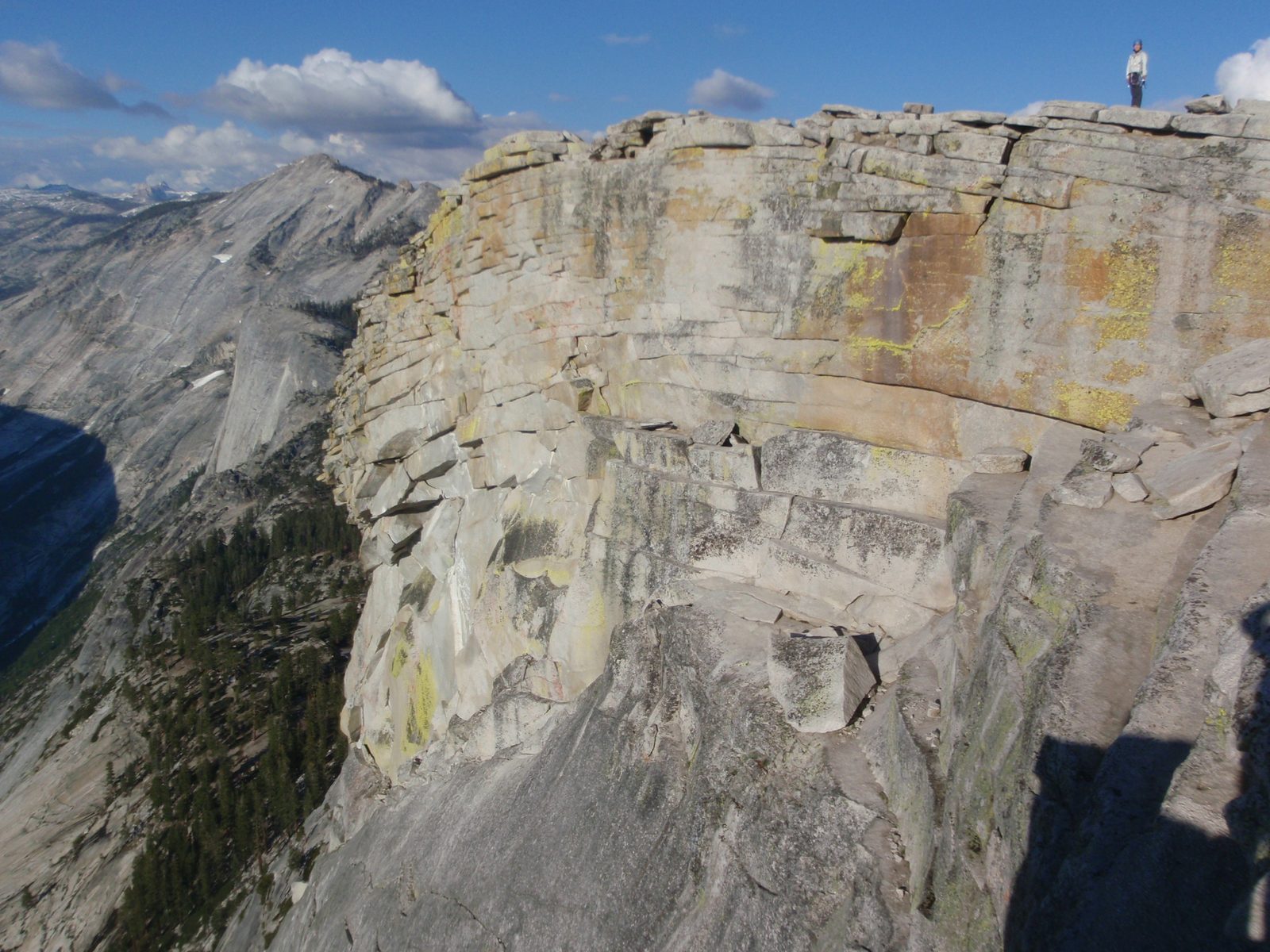 Monica standing on the edge of the northern face of Half Dome.