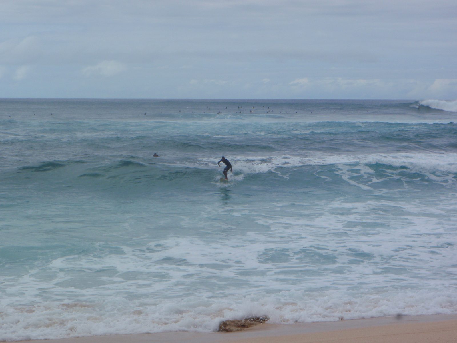 A surfer headed back for shore.