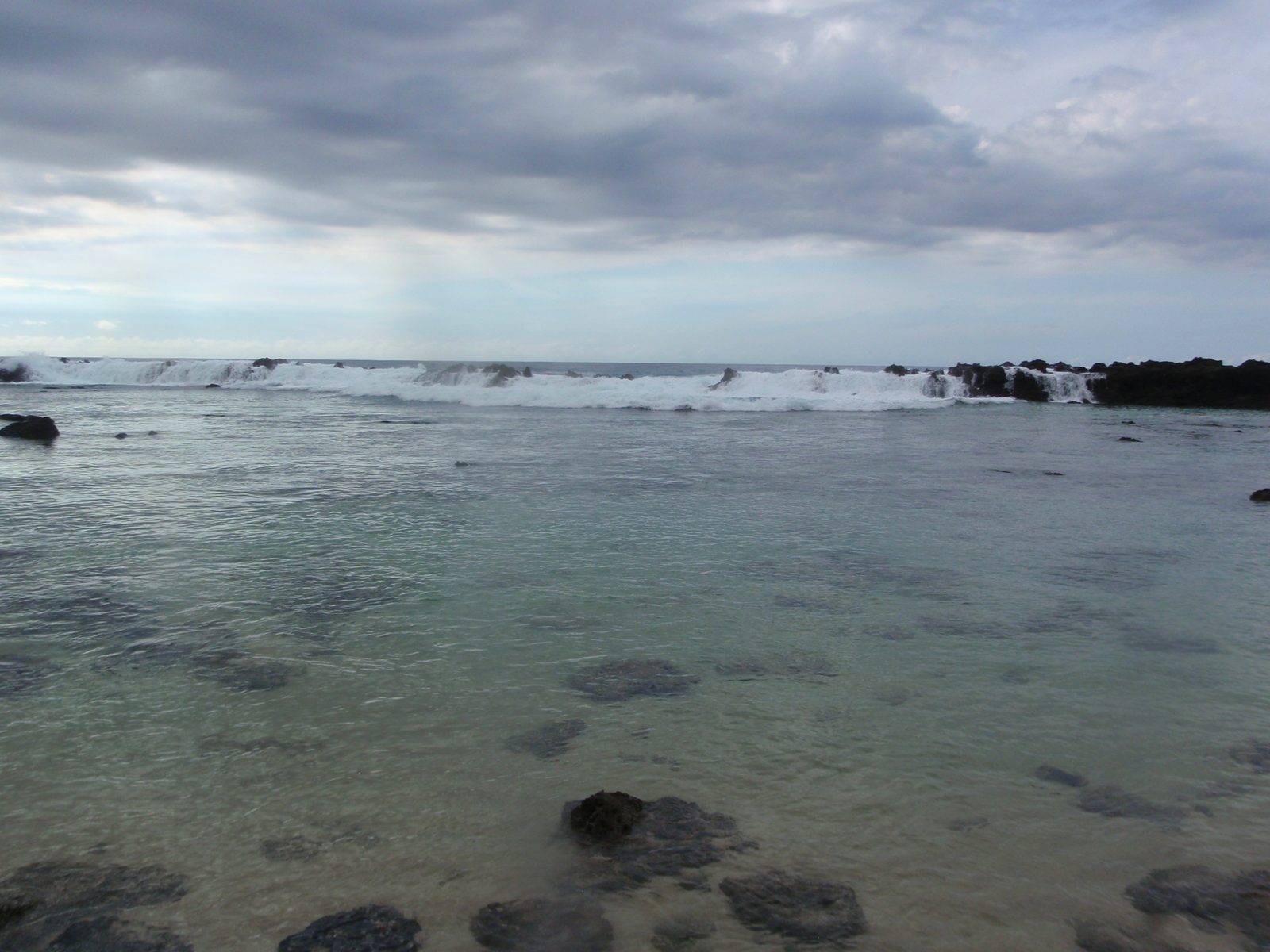 Occasionally a big wave would spill over the rock, but it would create a small ripple in the...