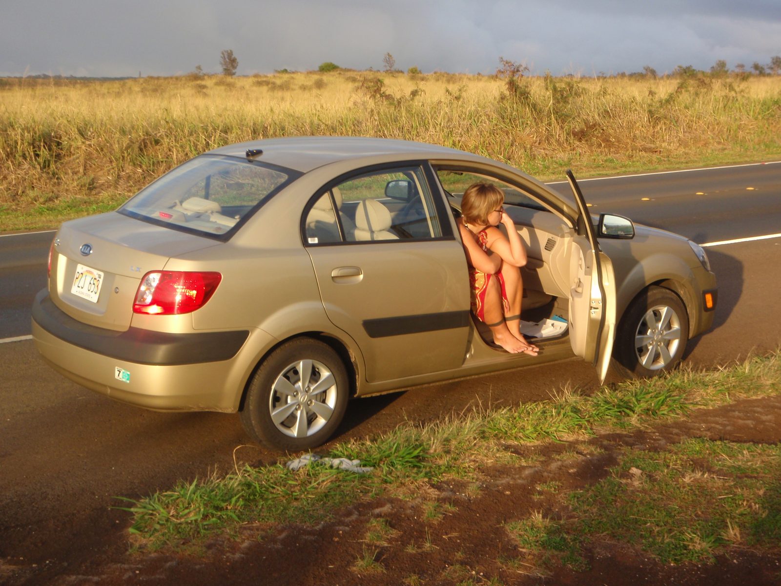 Lydia hanging out in the rental car: a beautiful tan Kia Rio.  Honestly, I like tiny rental...