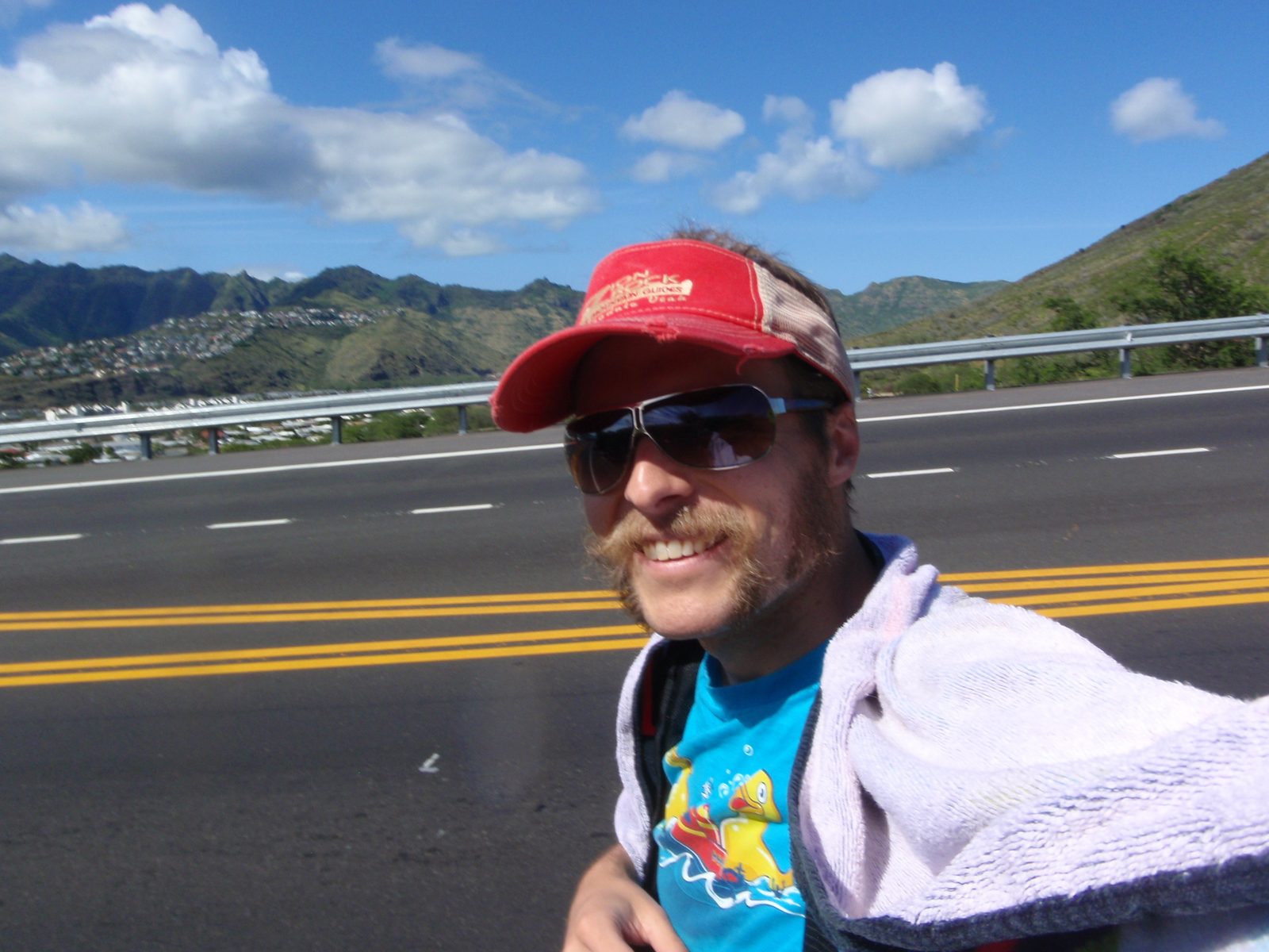 Using my towel and a shawl to ward off a sunburn, I walked back down the highway toward my car.
