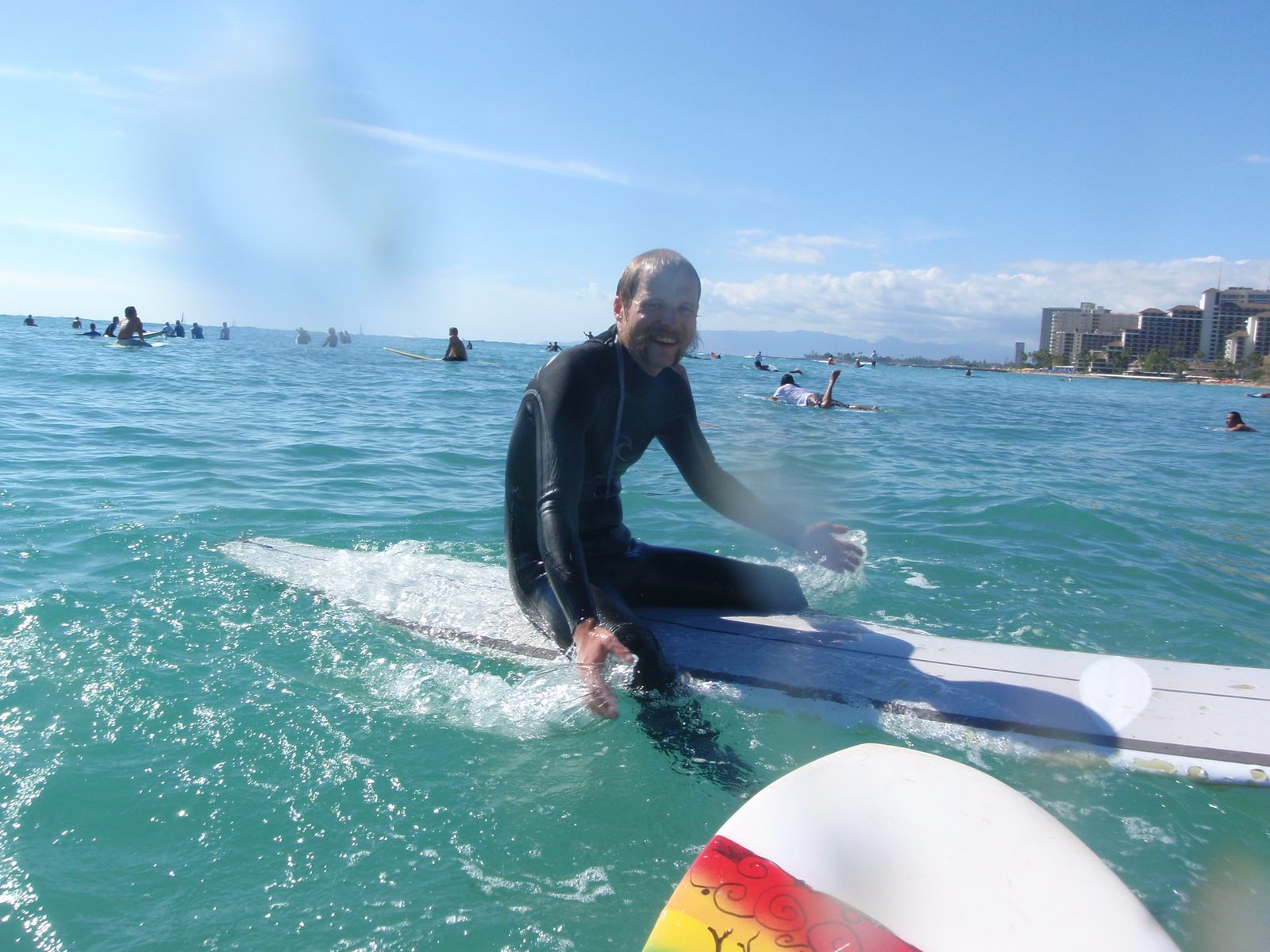 John, waiting for a wave with countless other surfers.  Despite the number of people, I didn't...