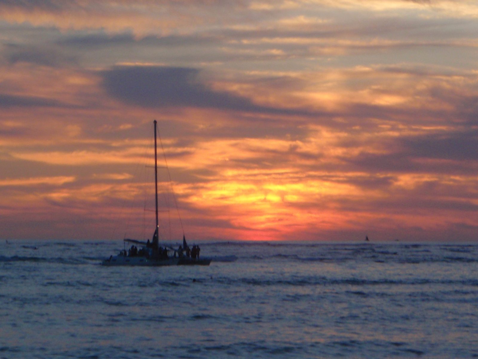 Sailboat full of sun-watchers.  
