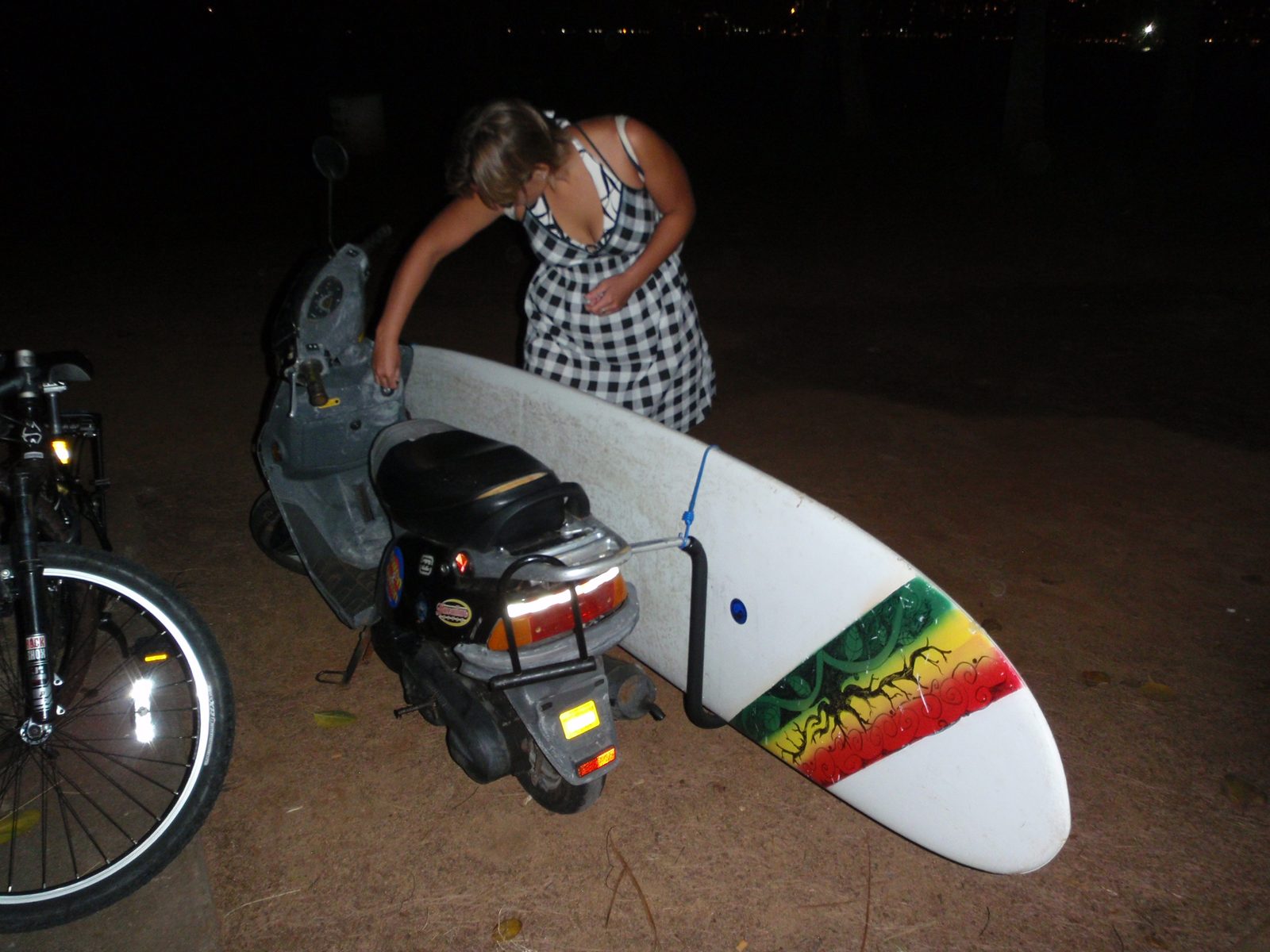 Pretty sweet rig, right?  A moped that holds a 10-foot surfboard.  Lydia says crosswinds are not good.