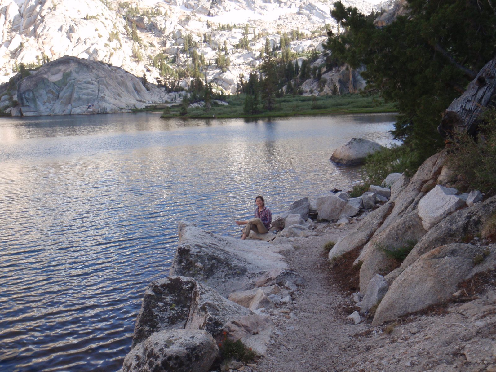Monica washing her swollen feet by the lake.