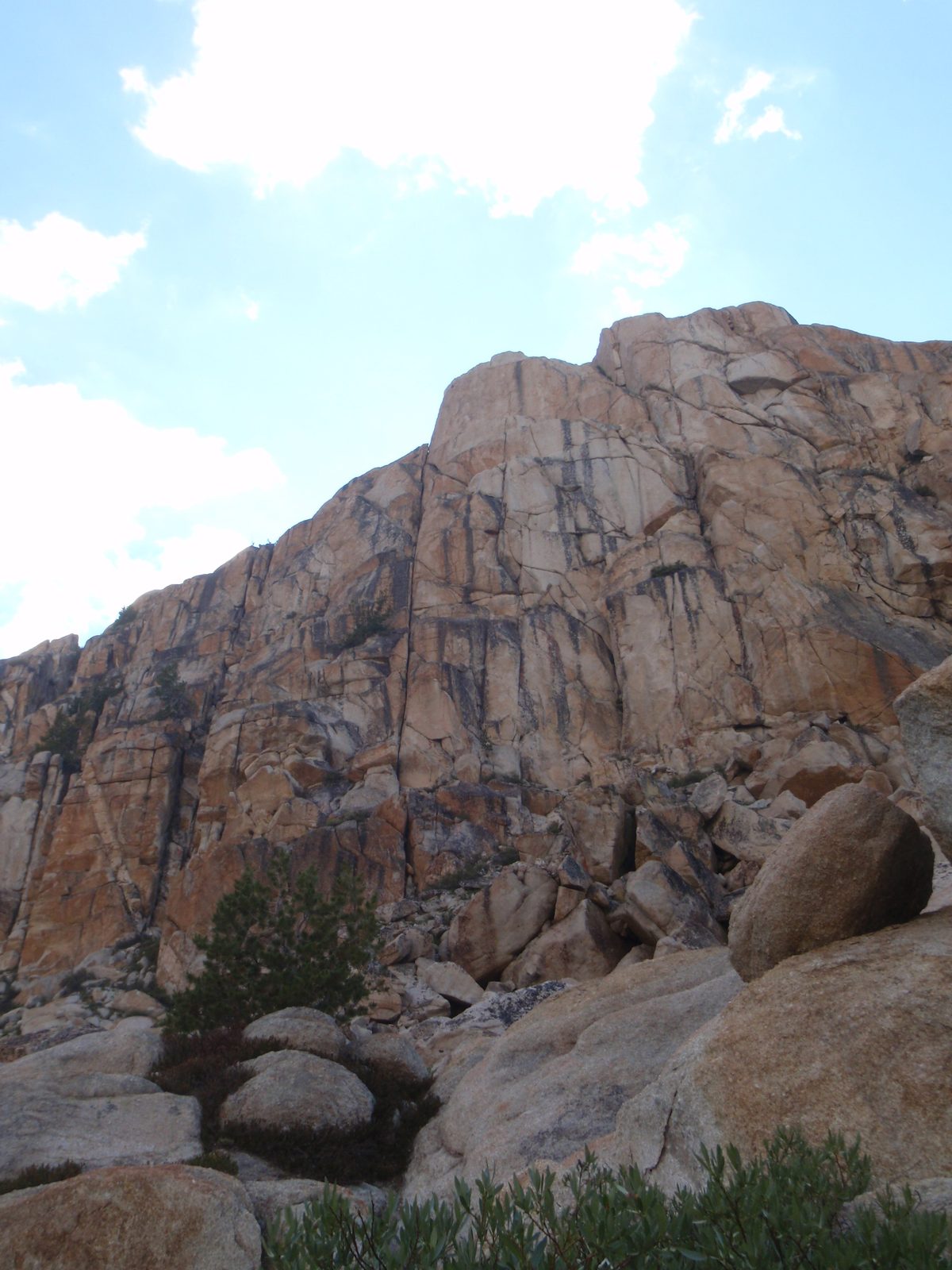 Steep, cracked cliffs looming above the lake.