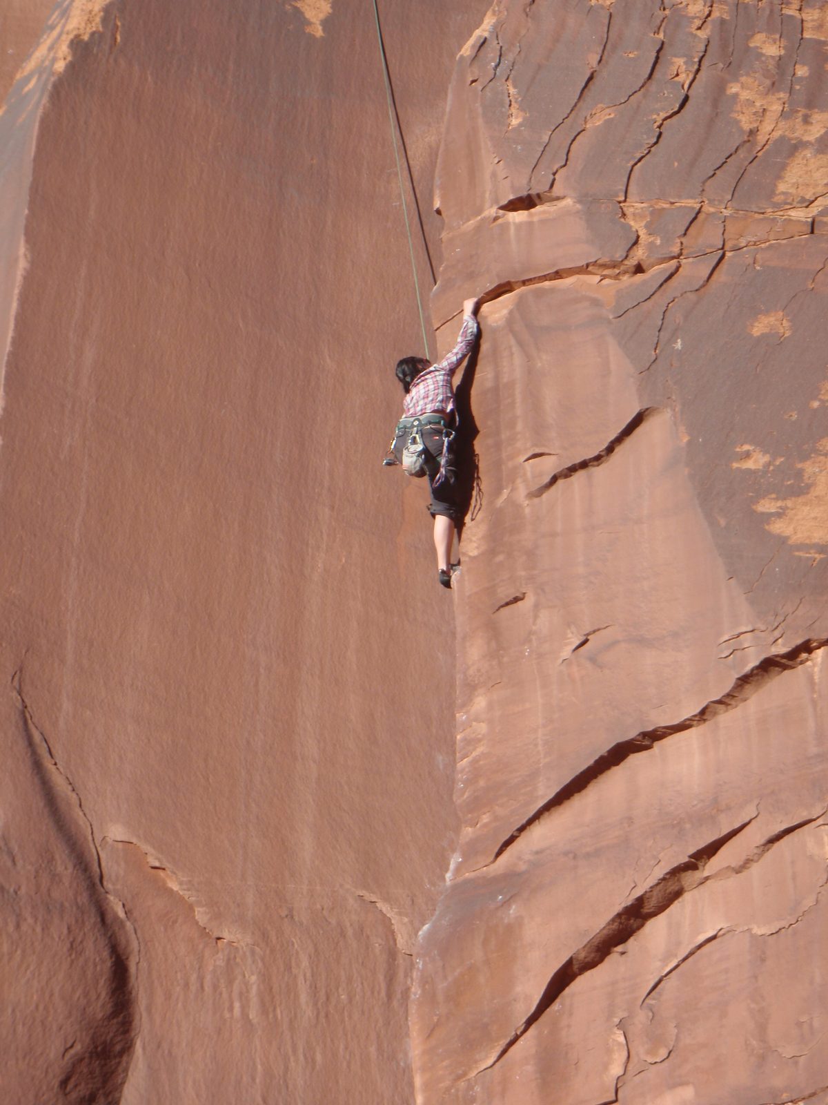 Monica, grabbing for a rare jug in Indian Creek.