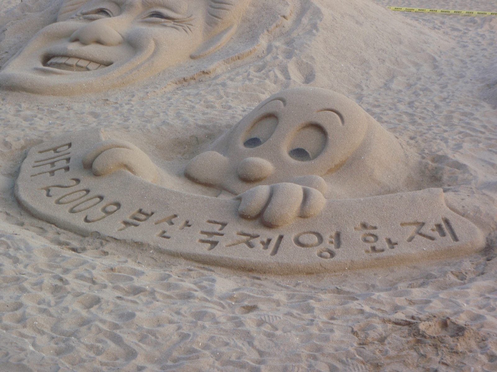 Cute sand sculpture.  I think in Korean it just says Busan international film festival.  I at...
