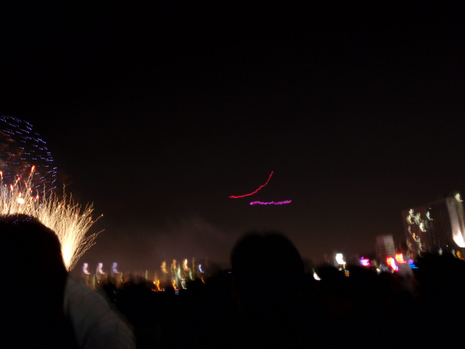The firework display included remote control planes with LEDs.  The planes appear as colored...