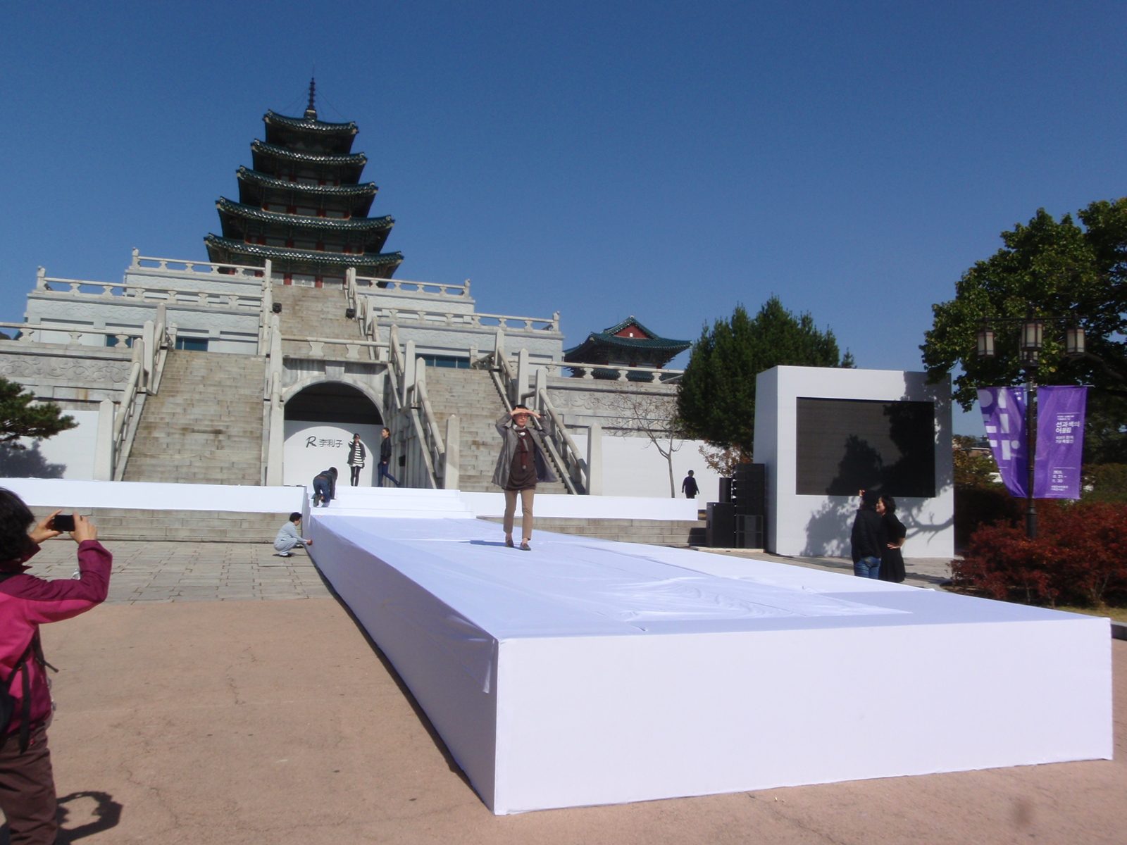 Out of place fashion show in the Gyeongbok temple complex.  All the models were shielding their...