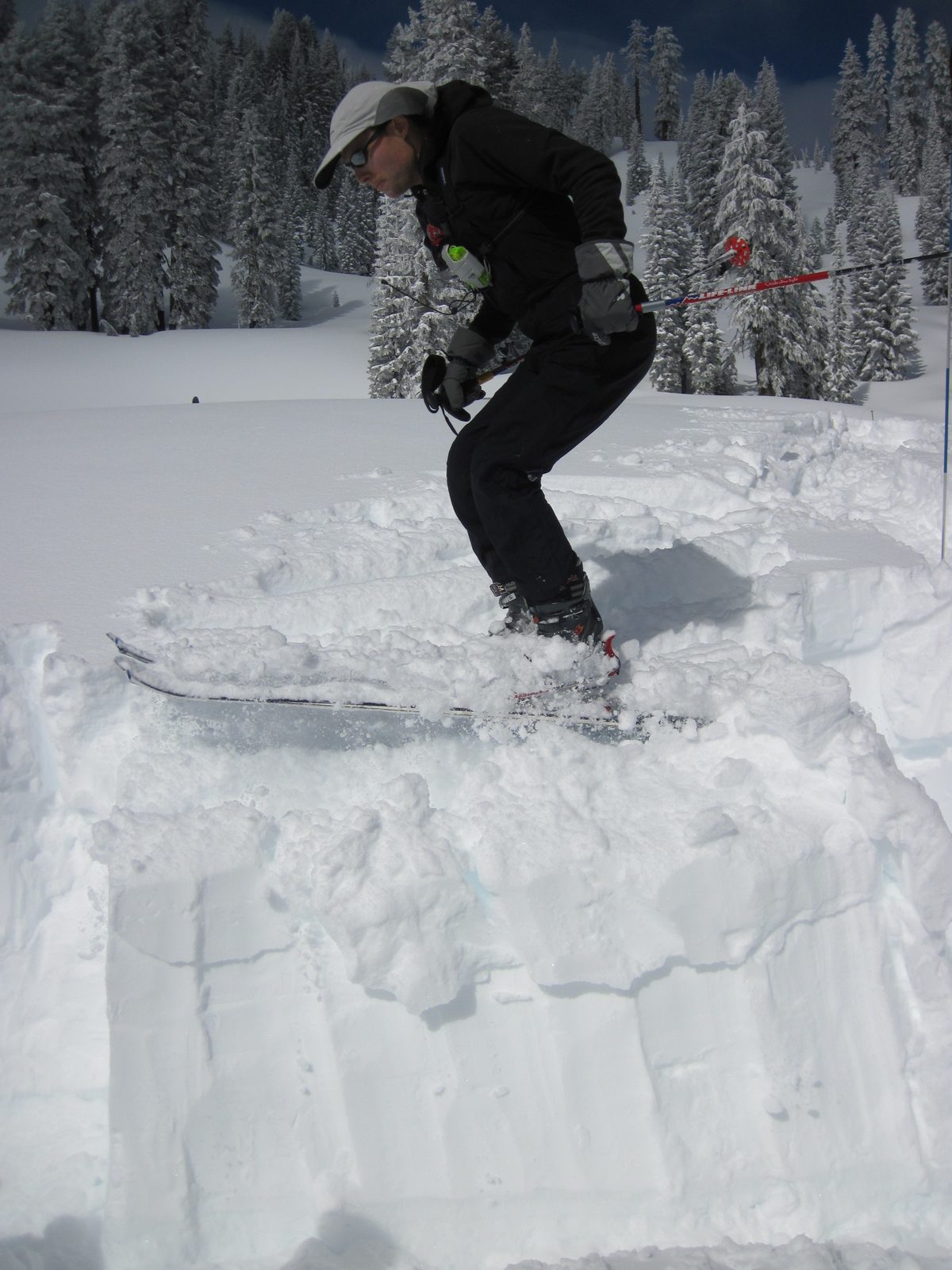 Jumping up and down on the snow column to test the strength of the snow.