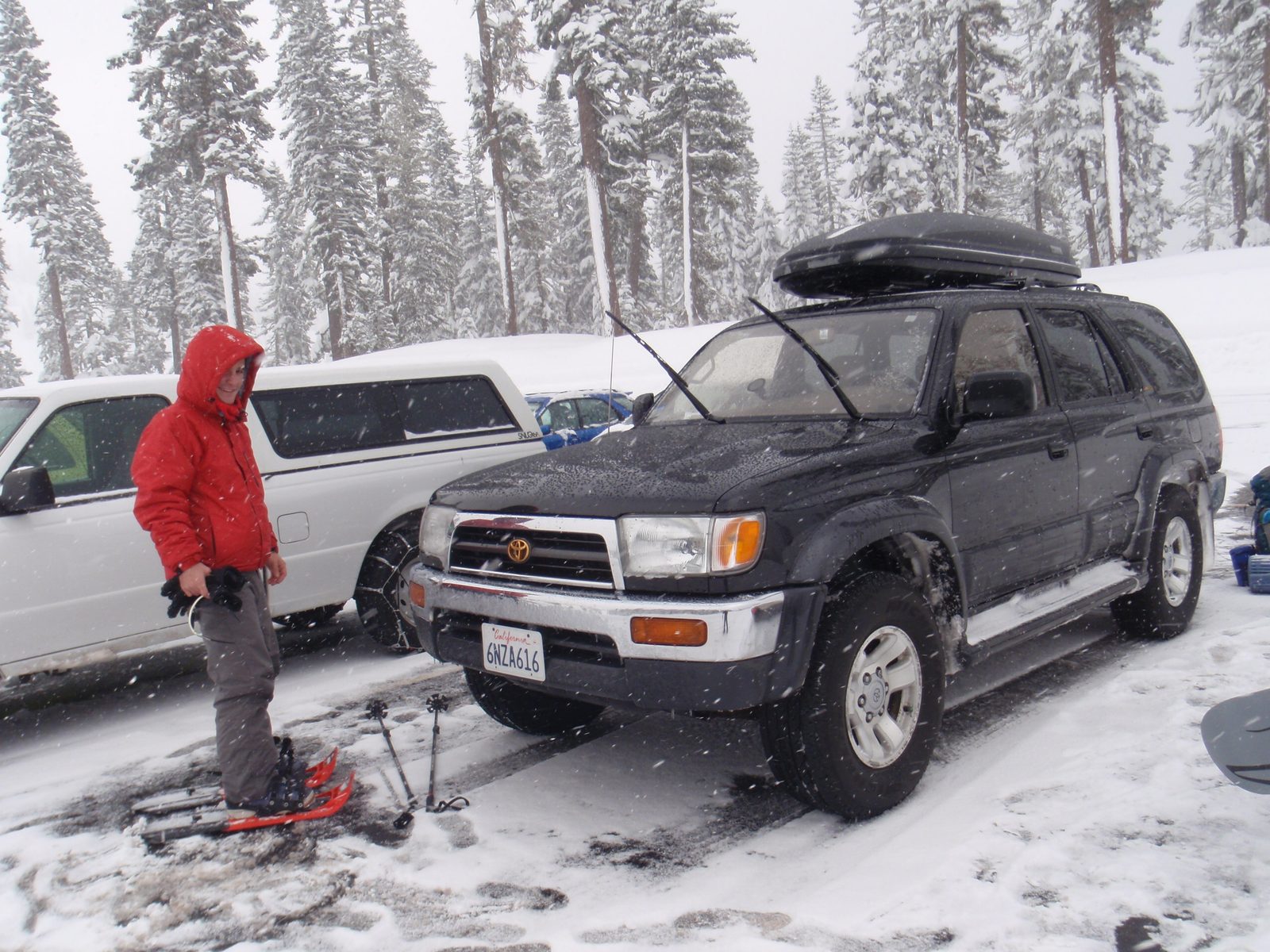 Vinnie trying on his rented snowshoes with plastic "tails" for deep snow. Yang brought his...
