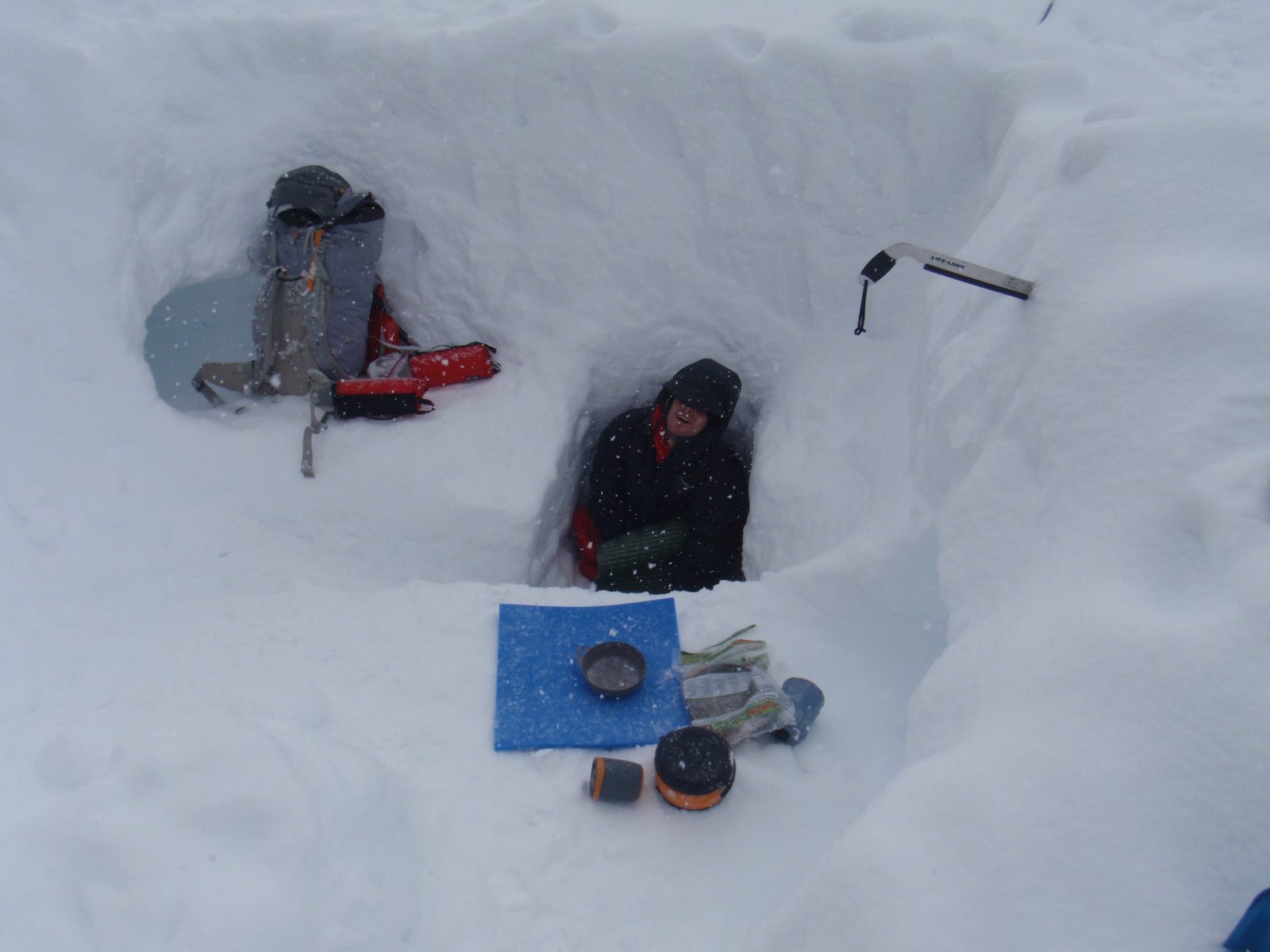 A picture of Vinnie emerging from the entrance to our snow cave. With more time, it would have...
