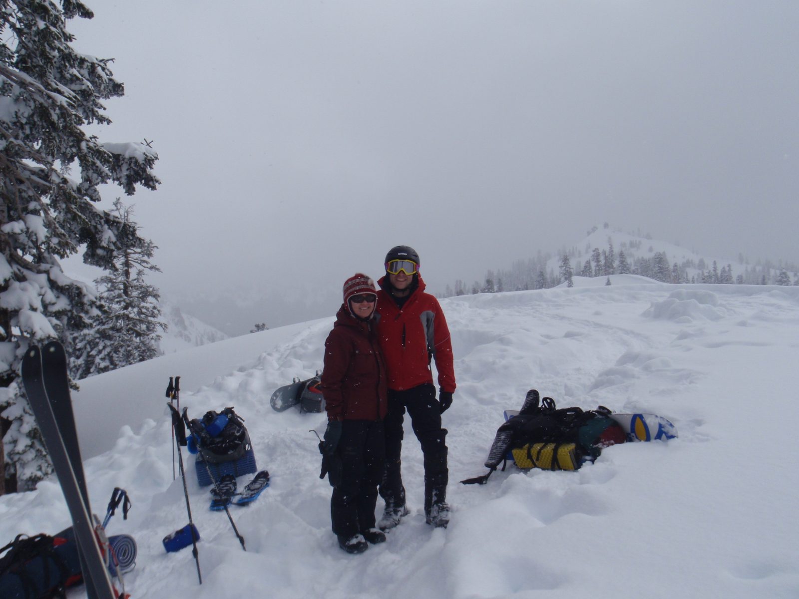 John and Monica, as we pack up and get ready to head back home. The chimney of our snow cave is...