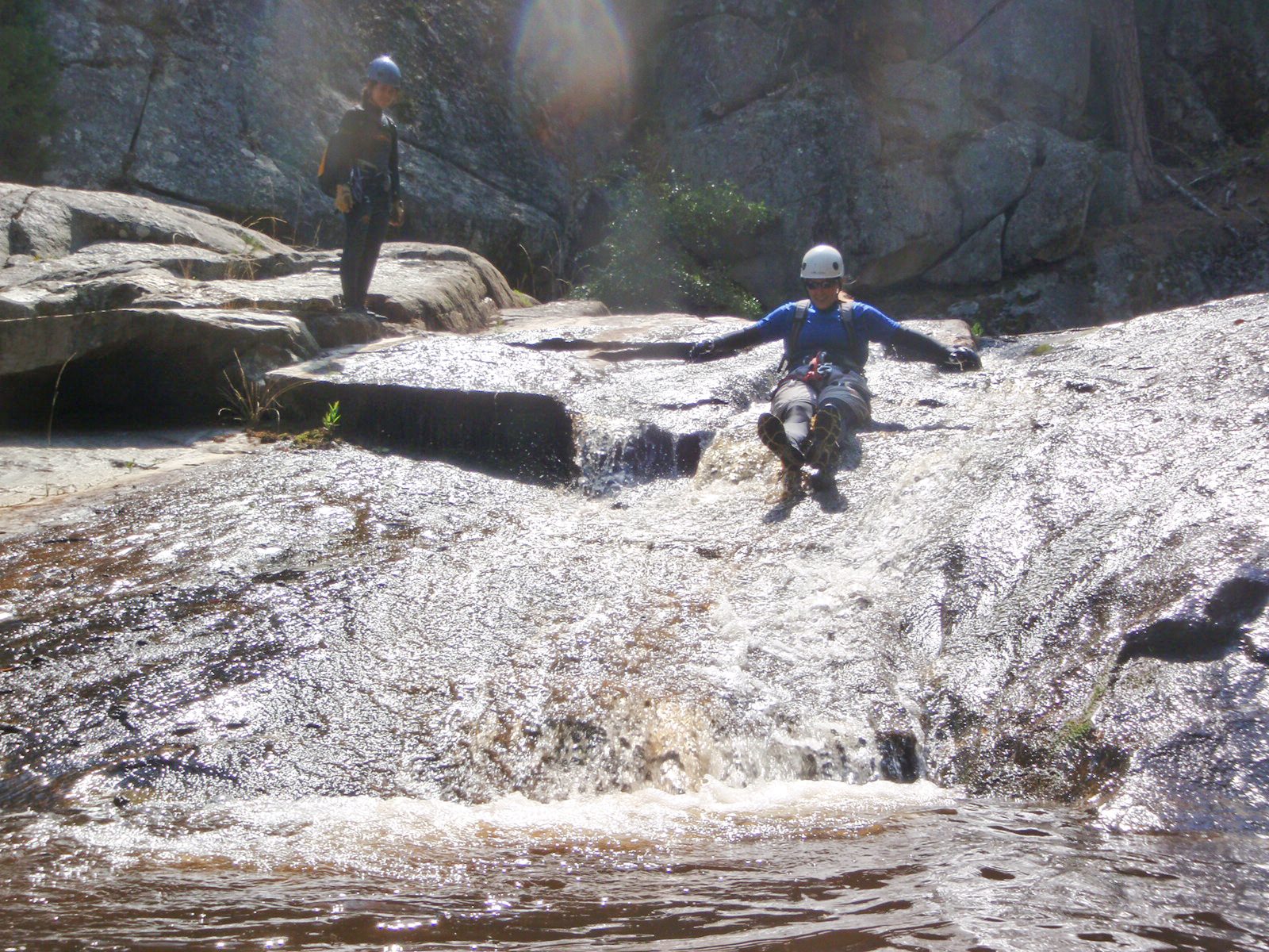 Catherine tests out a water slide in Upper Little Utah Brown, and Monica lines up waiting her turn.