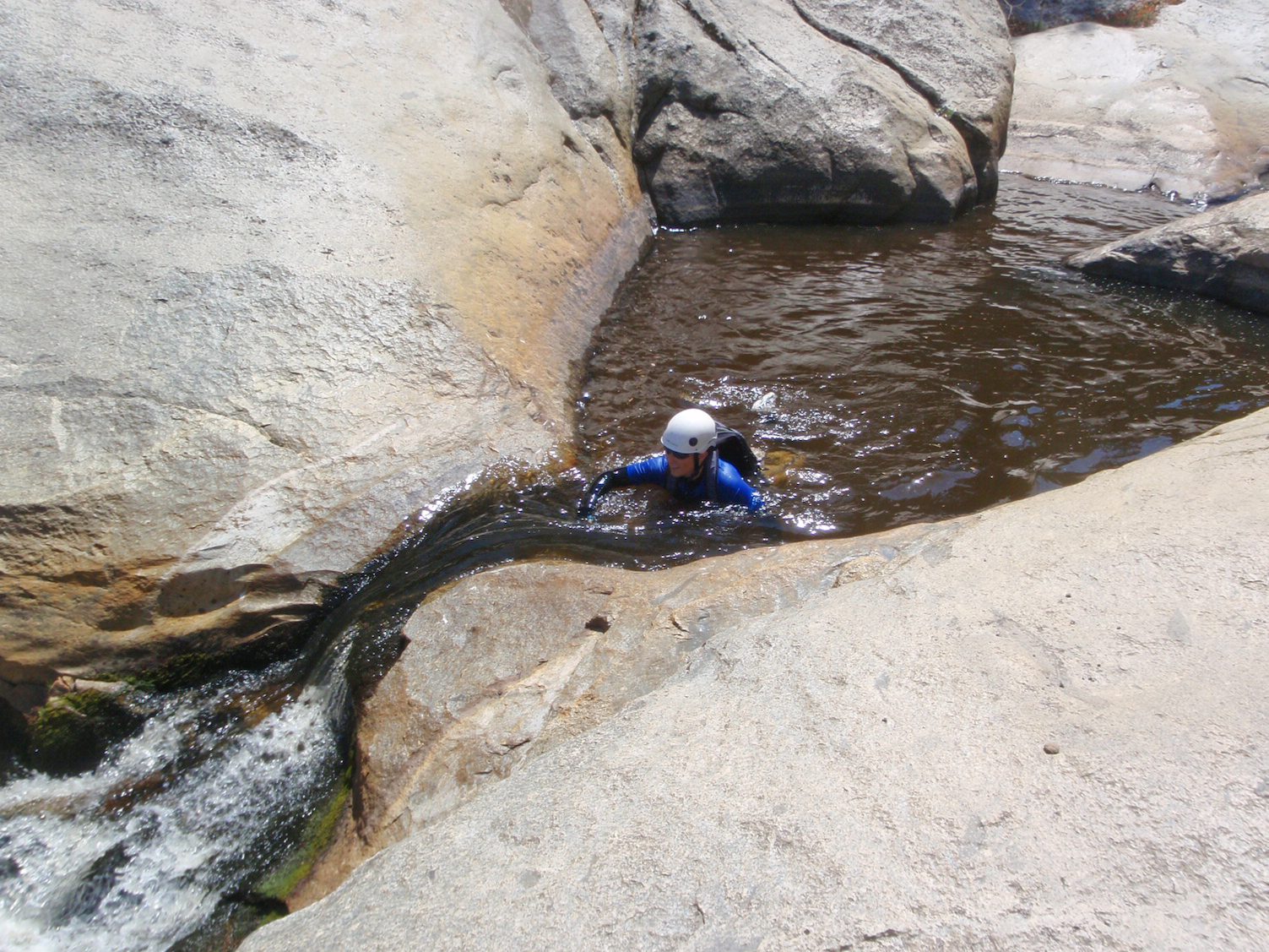 Catherine swims up to a small waterfall / slide.