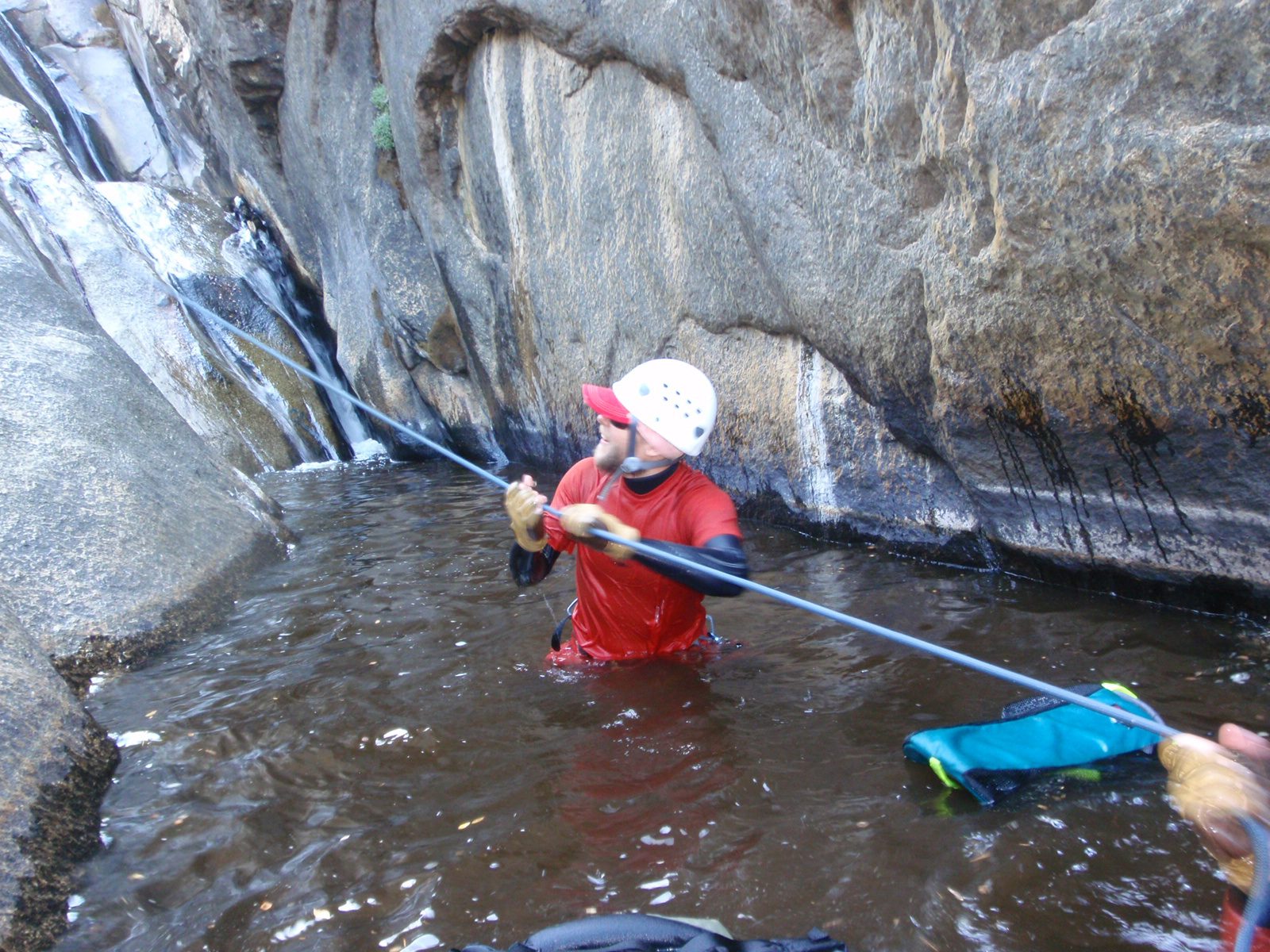 John, helping Joel try to tug the rope down, before realizing how stuck it was.