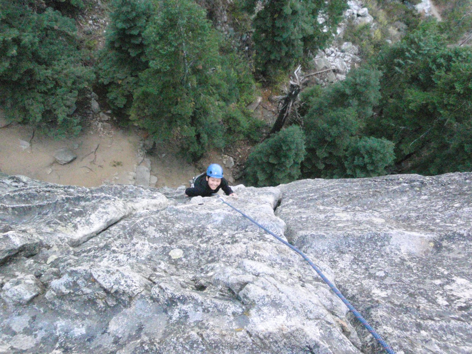Monica climbing the first pitch of Surrealistic Pillar (5.7).