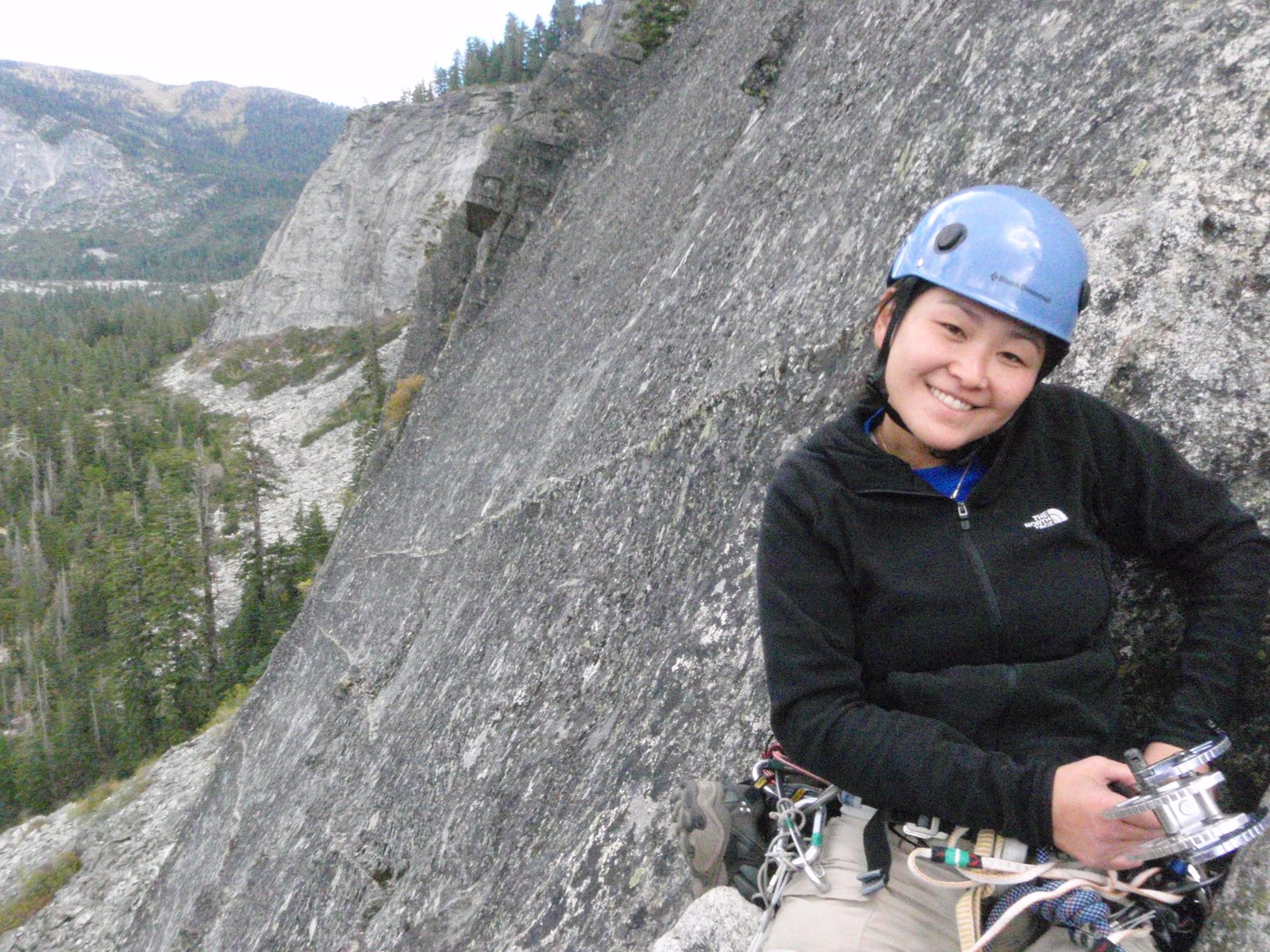 Monica, at the top of the second pitch of Surrealistic Pillar (5.7), with a large cam in hand.