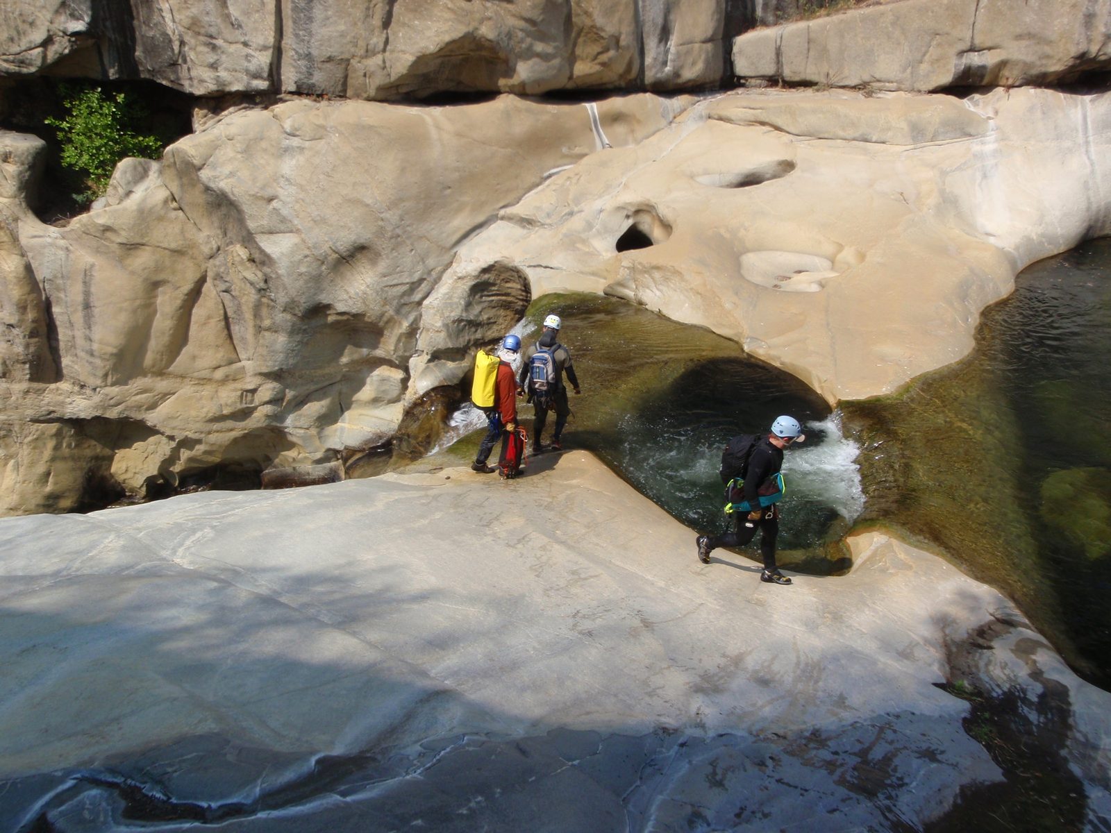 Joel, Andy, and Mike, looking where to set up a body belay to check out the first jump.