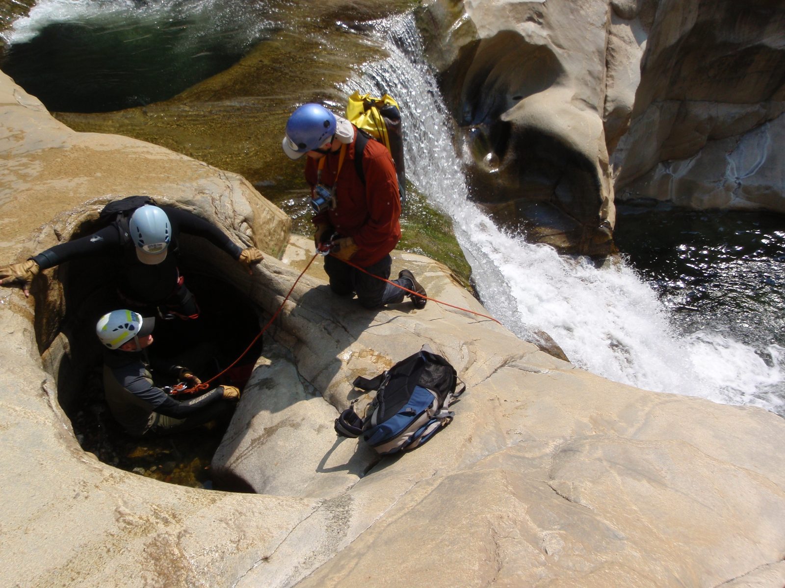 Joel getting ready to rappel off Andy and Mike's body weight.