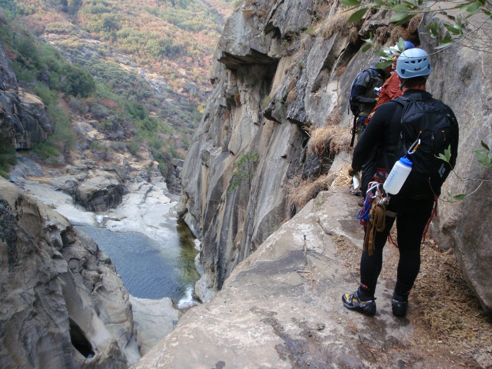 From front to rear, Mike, Joel, Andy, inspecting the rappel anchor of our 120 ft rappel into the gorge.