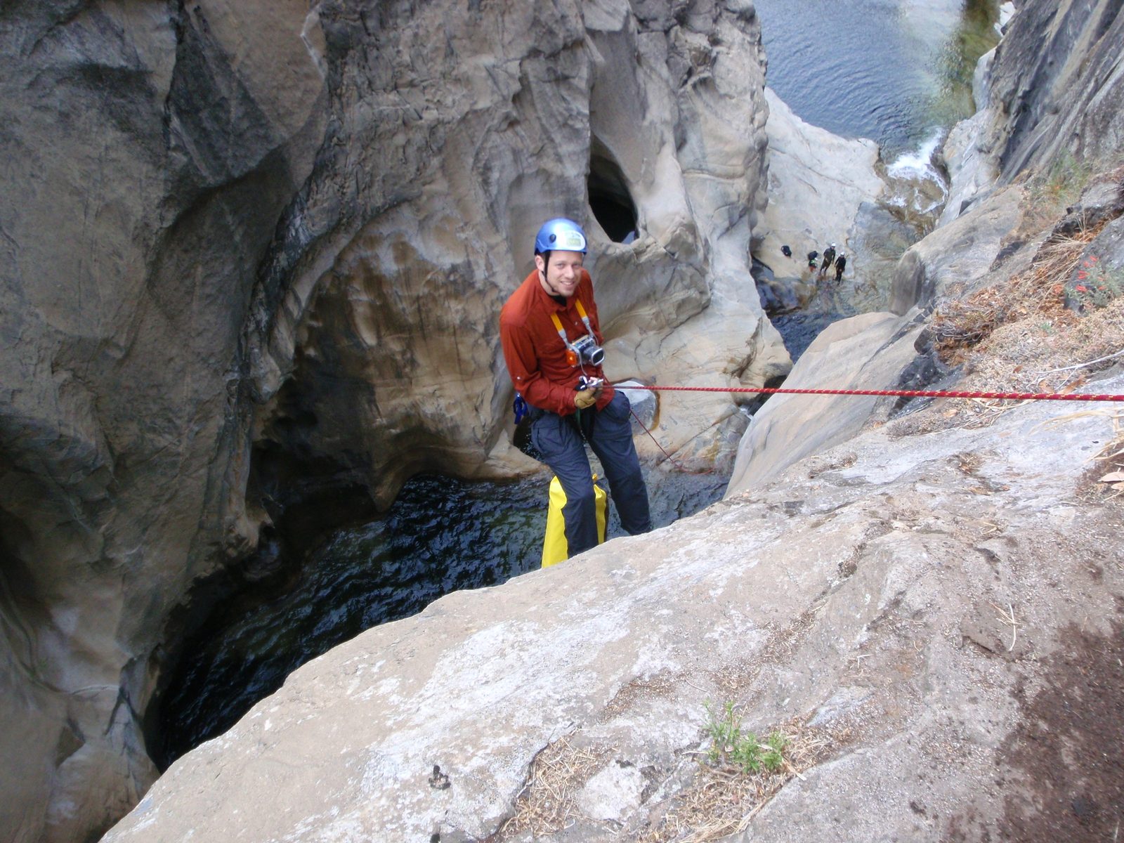 Joel, on the 100 ft rappel, hanging his bag from his harness for better weight distributions. ...