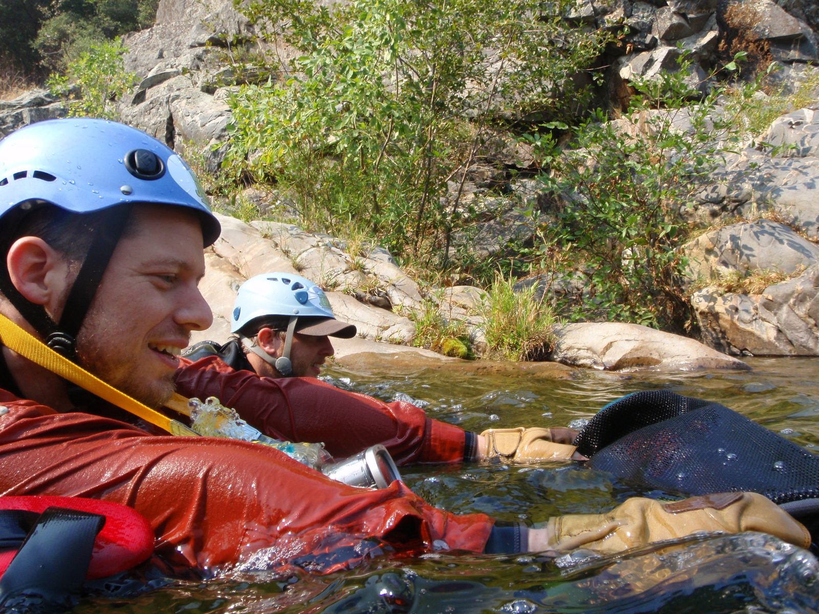Joel and Mike (rear) swimming down river, joel pushing with him one of our ropes (in a bag).