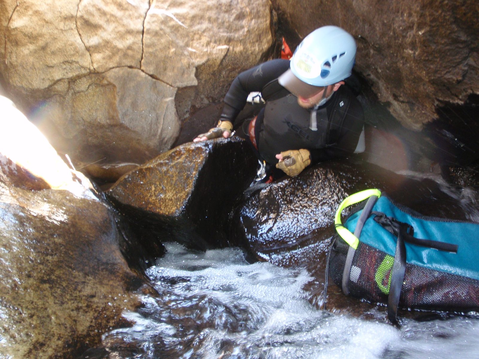 Mike, squeezing through a tight passage in a large boulder field.