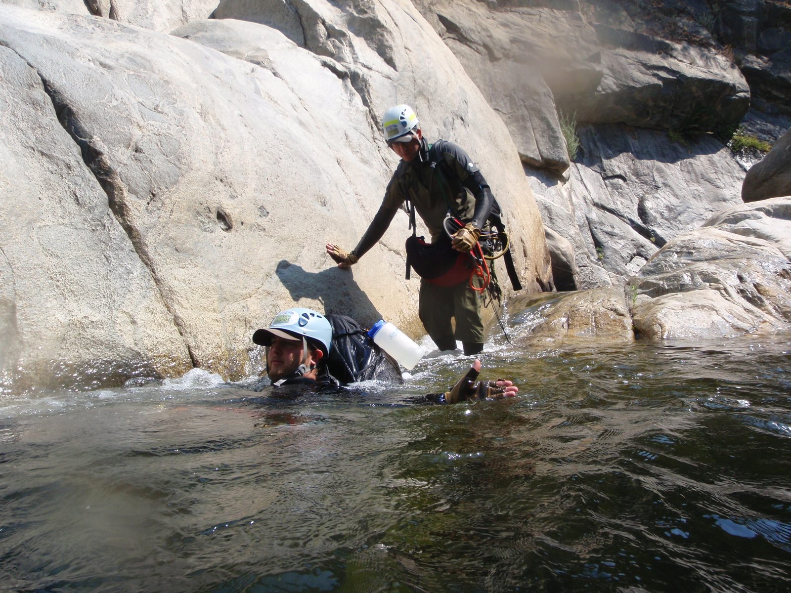 Mike doggy paddling and Andy behind him about to get back in the river.