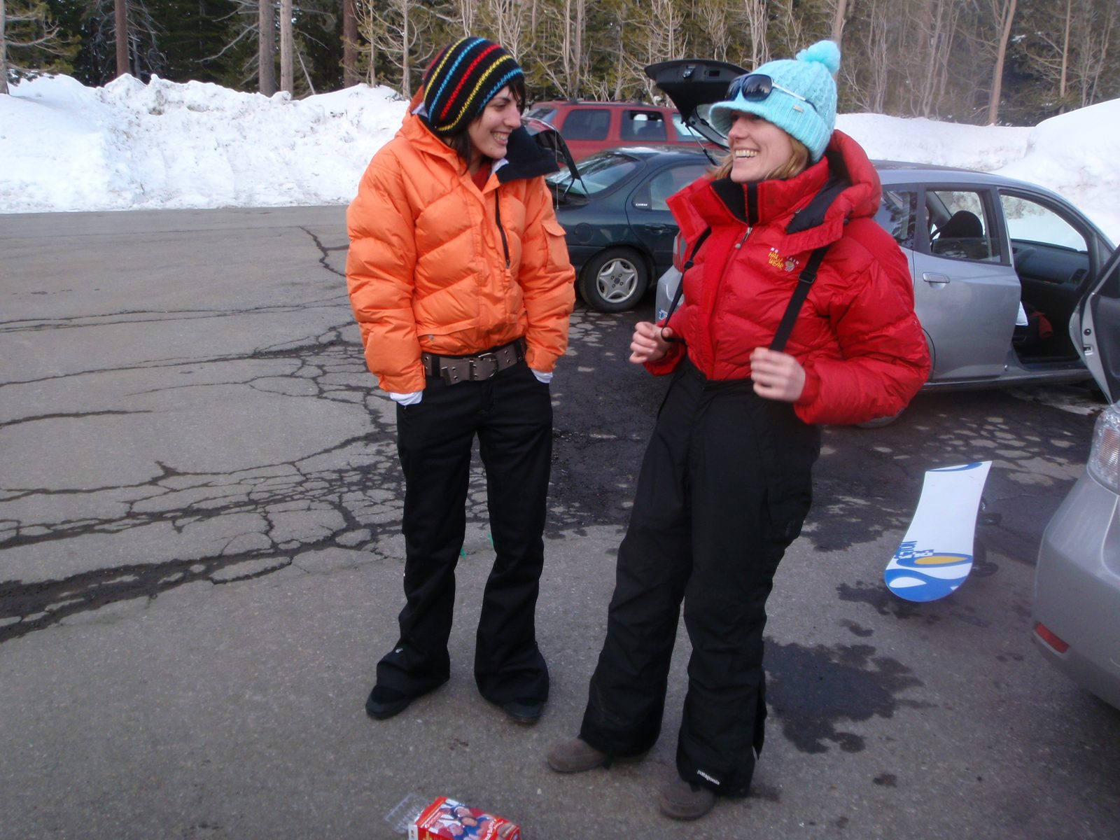 Liz and one of her friends, comparing puffy coats in the parking lot.