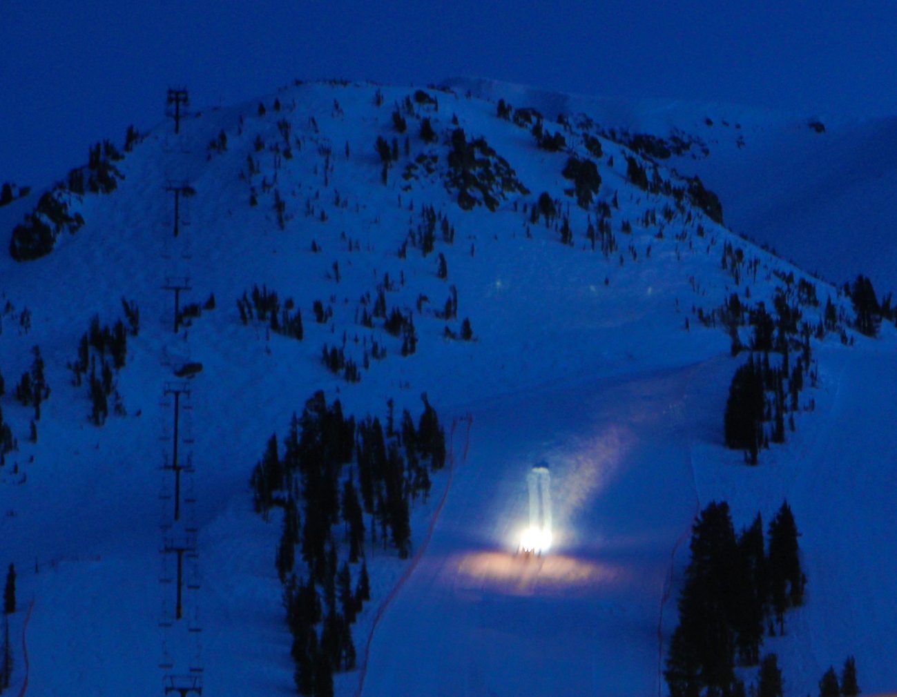 Time-lapse shot of a groomer working its way down a slope.  Mammoth grooms a lot of its terrain...