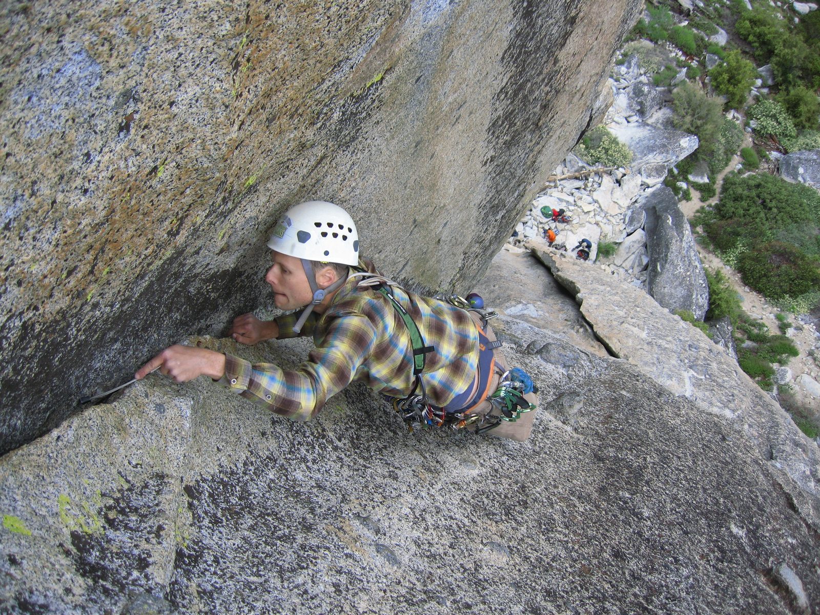 Placing another nut. Monica, my faithful belayer, has a purple helmet which is visible right below.
