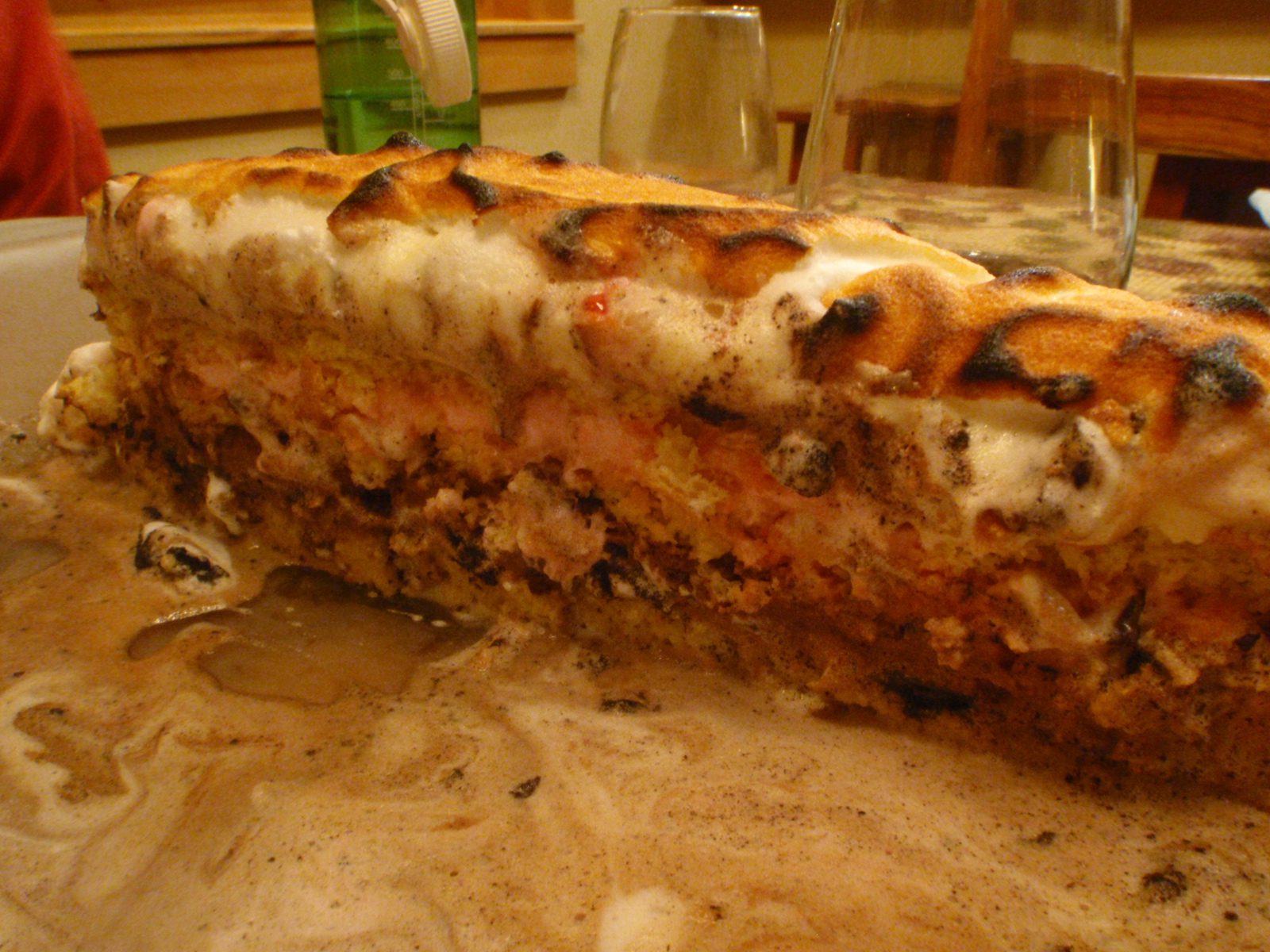Oreo peppermint bark Baked Alaska showing its layers - from bottom to top: chiffon cake, vanilla...
