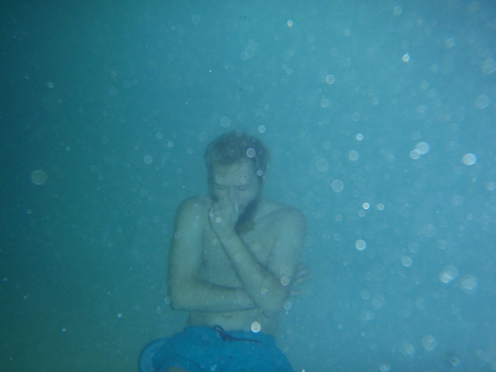 John, holding his breath for a long time on the bottom of the pool.