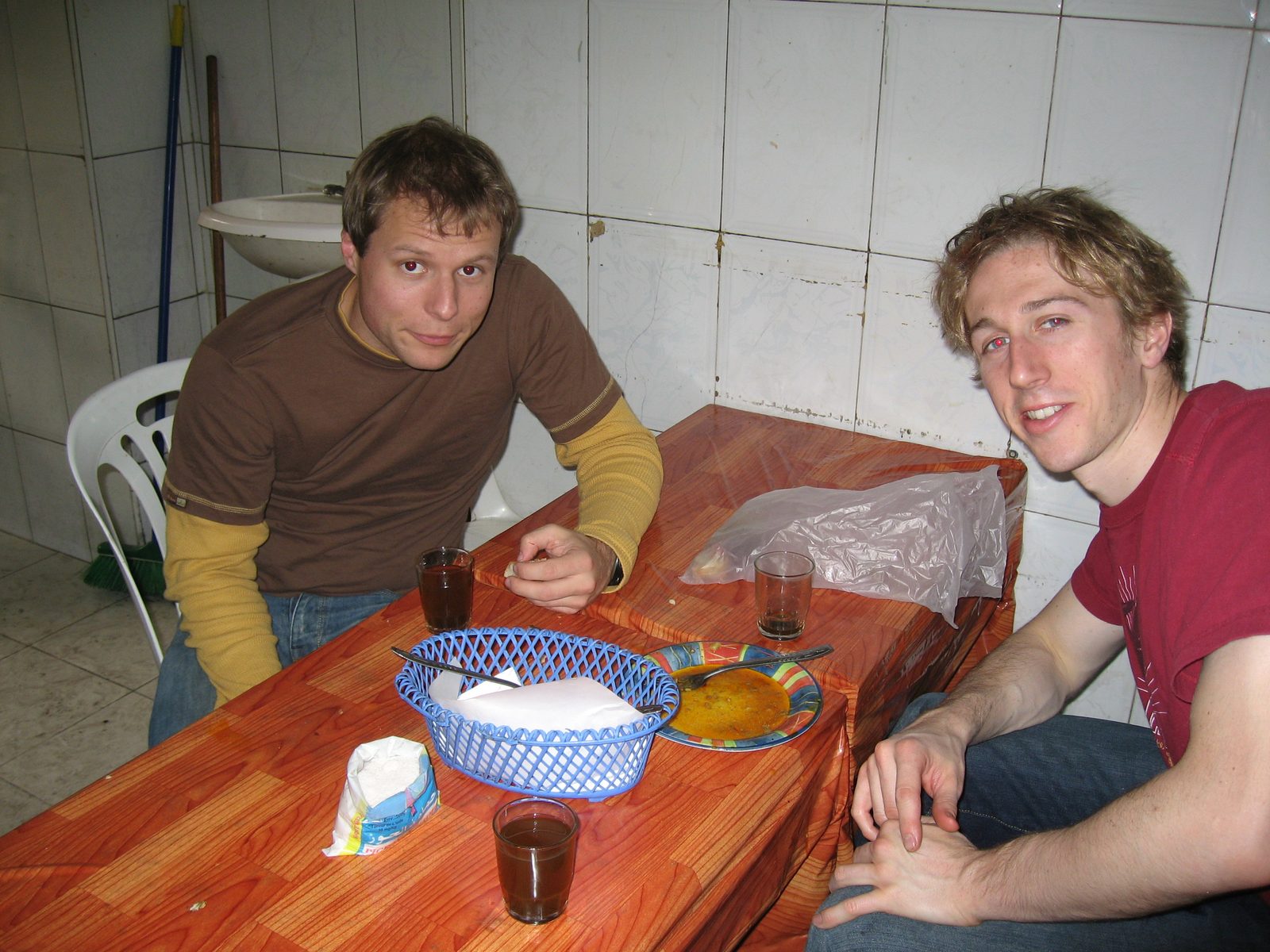 Giving a hole in the wall literal meaning, John, Trevor, and Heidi (not pictured) eat in an...